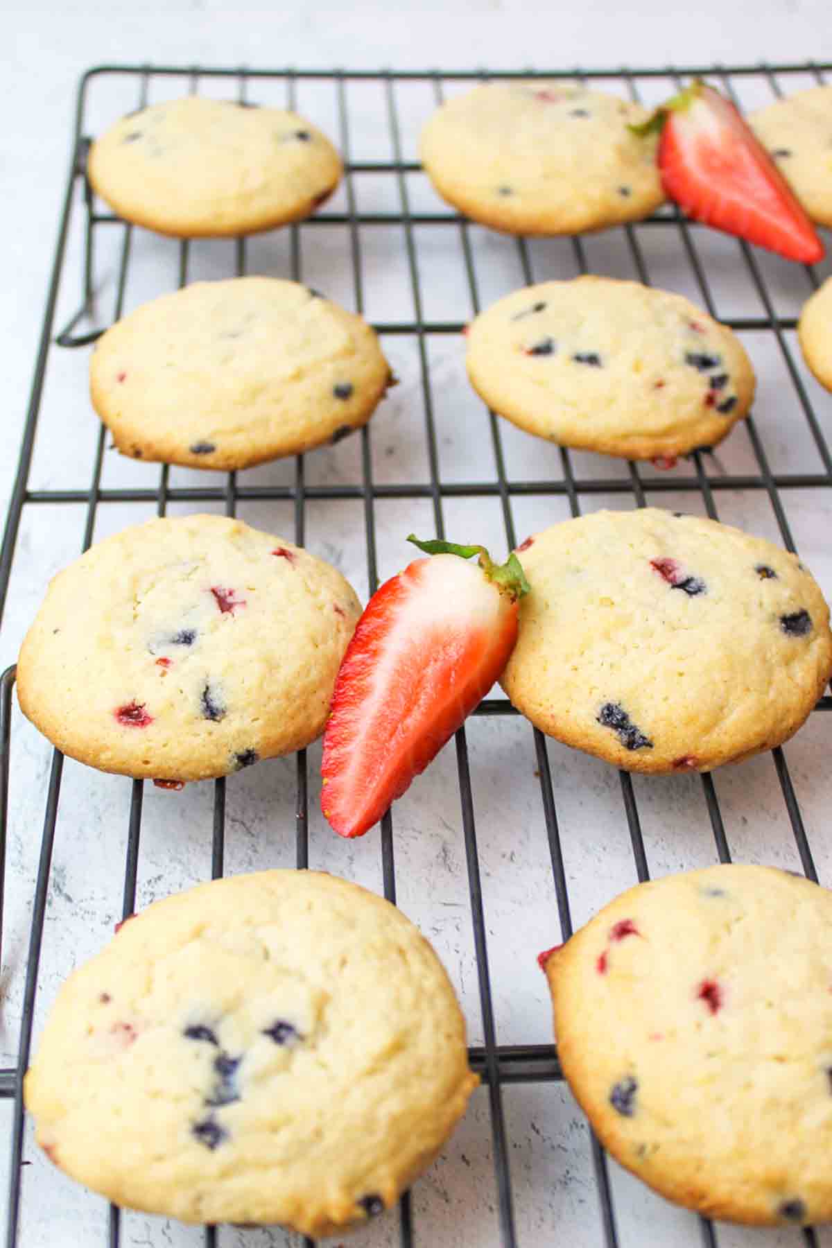muffin mix cookies on a wire rack with fresh strawberry slices