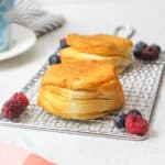 air fried canned biscuits on a wire rack with fresh berries.