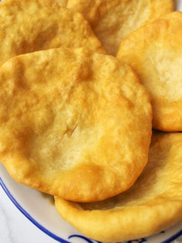 fry bread pieces laying on a plate.