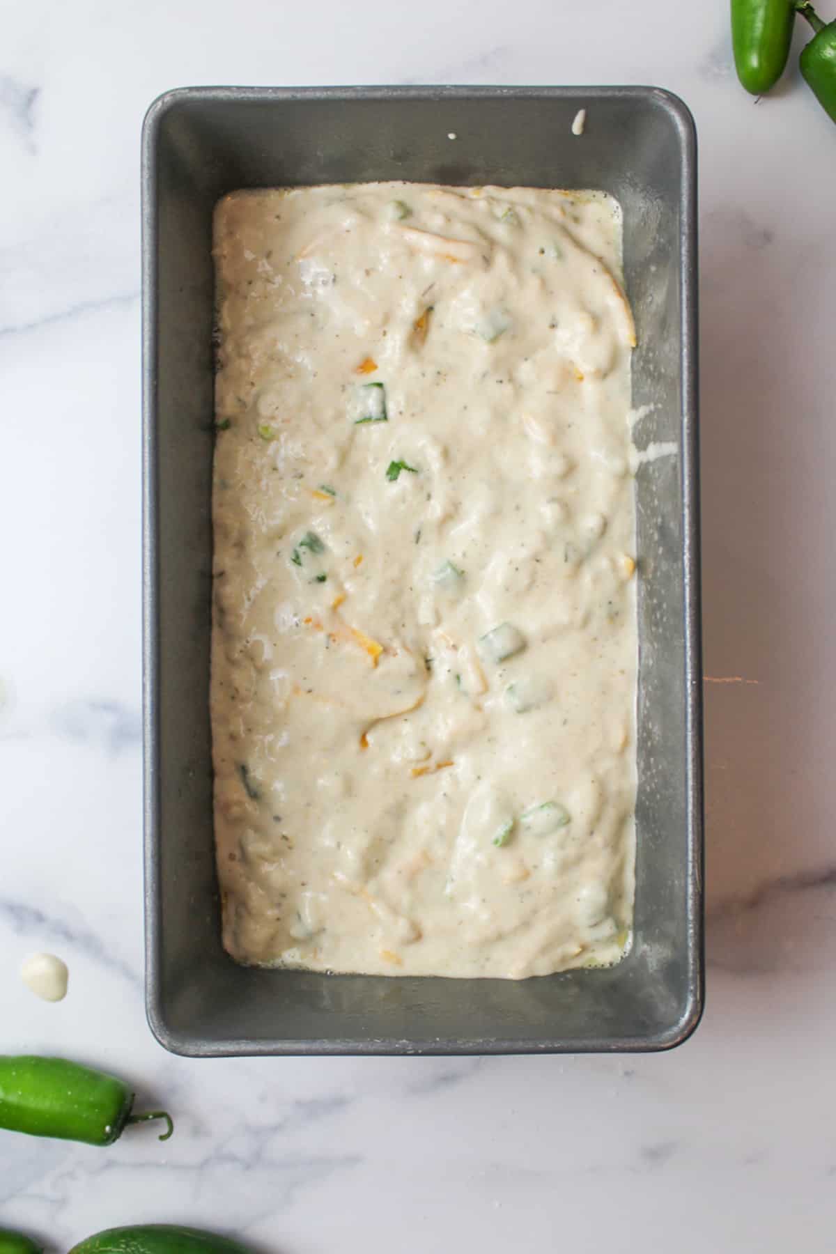 jalapeno cheddar beer bread batter in a bread pan.