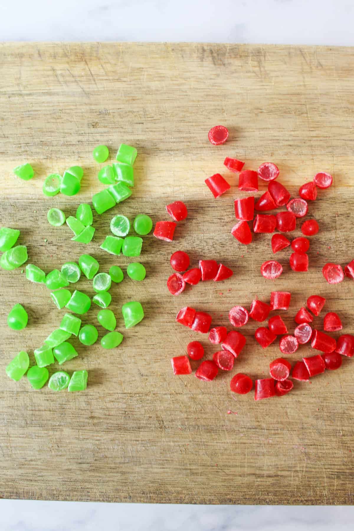red and green mike and ike candies on a cutting board chopped into pieces