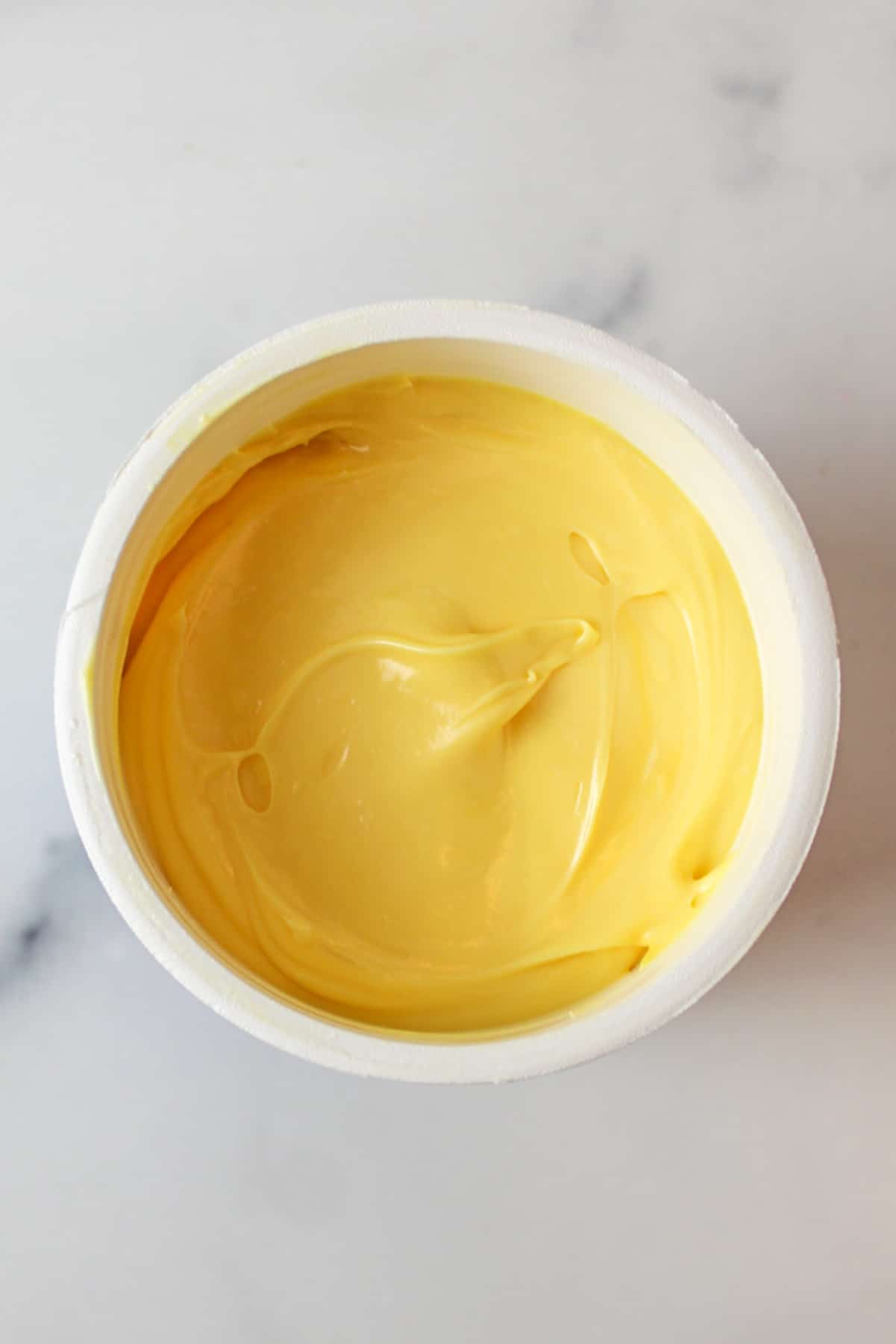 yellow colored frosting in a can