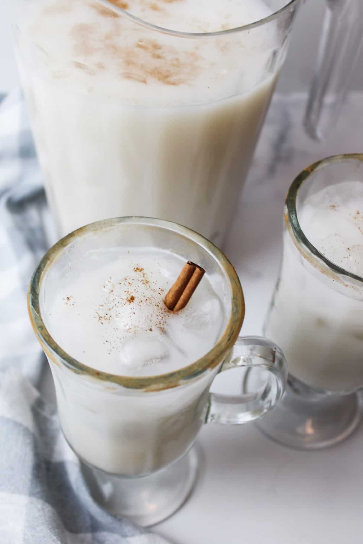 angled view inside of a glass of ice cold horchata with cinnamon