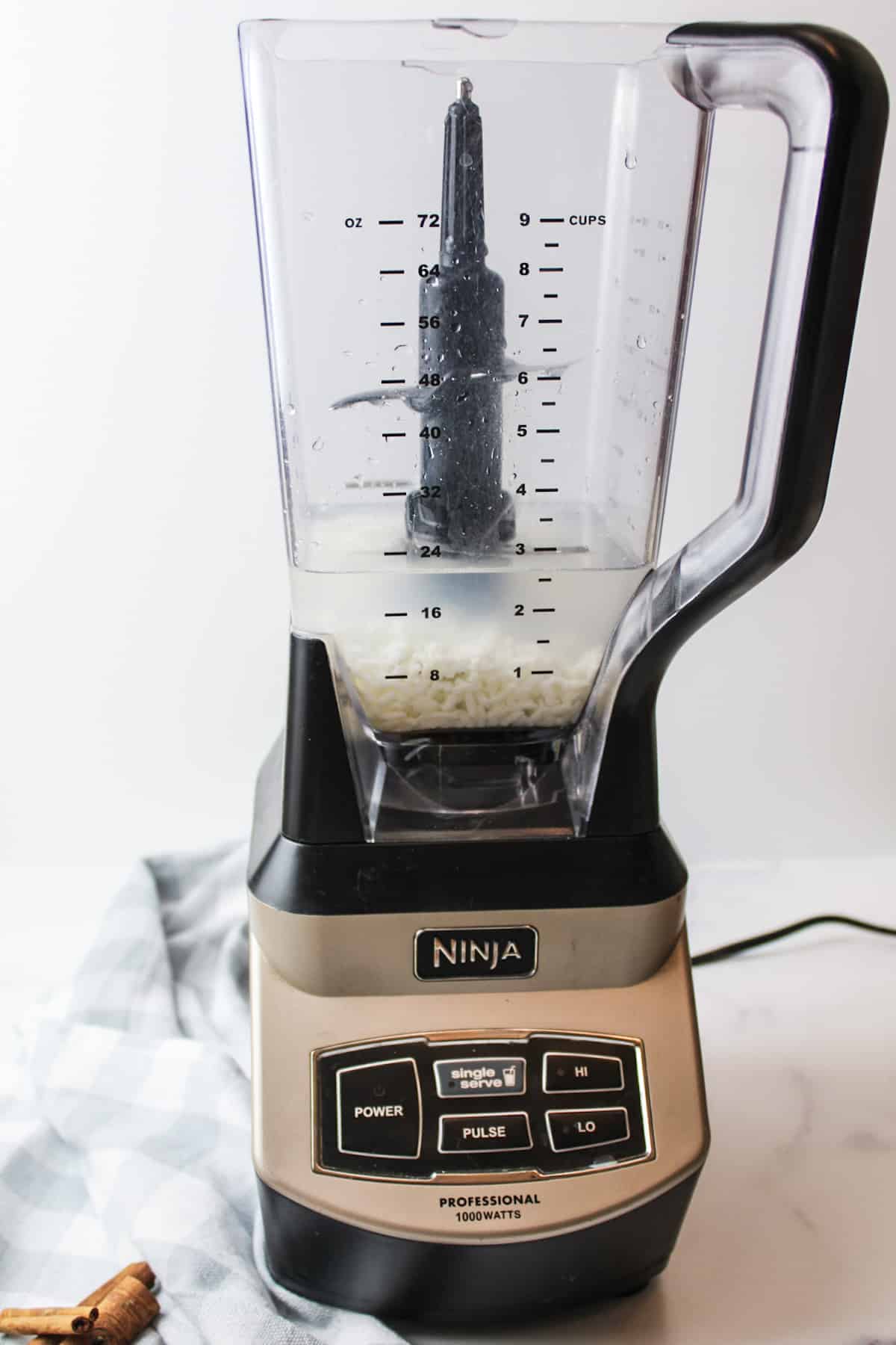 a blender full of water rice vanilla and cinnamon.
