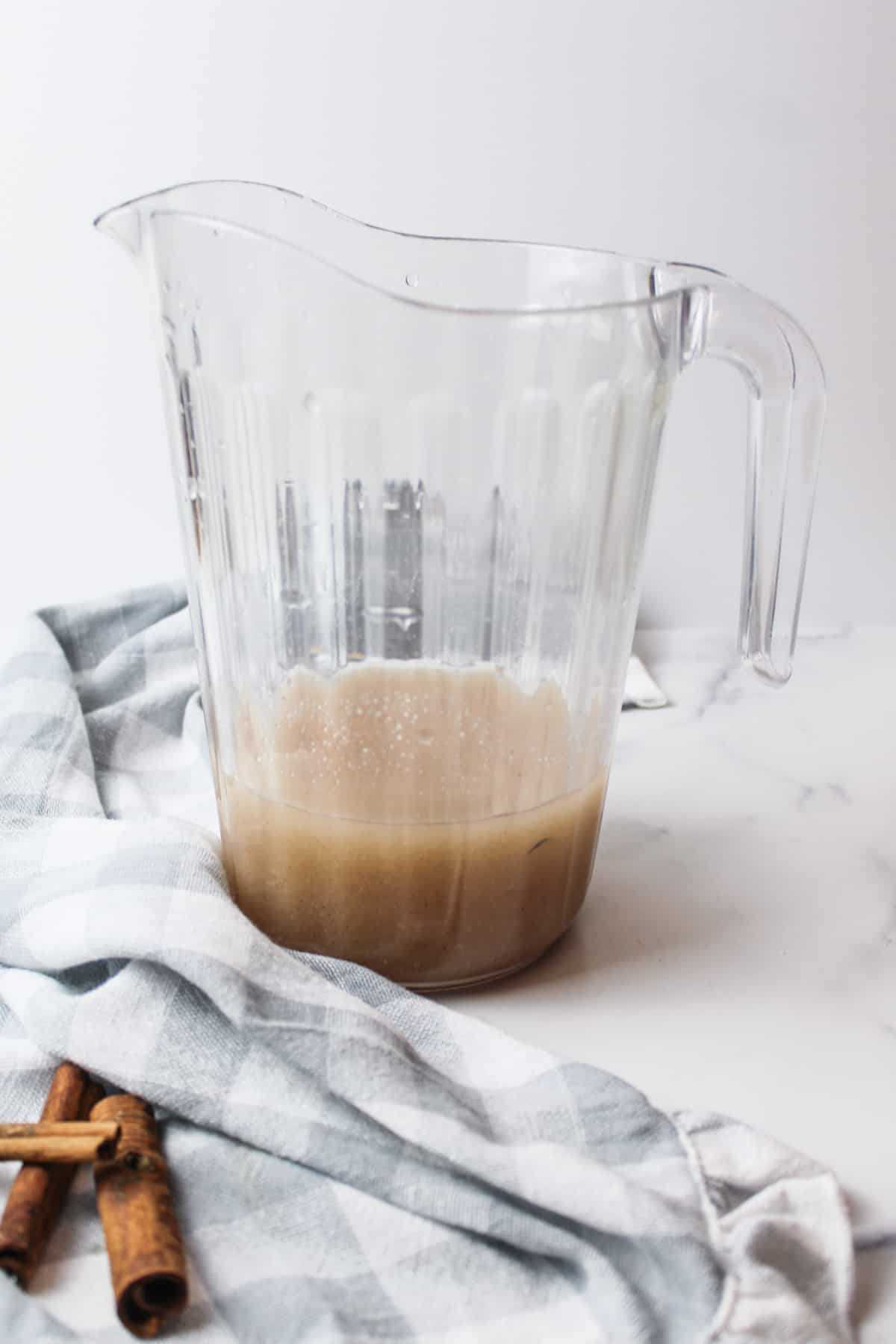 strained cinnamon rice water in a pitcher.