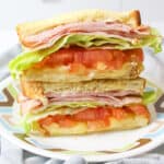 two stacked halves of an air fryer club sandwich on a plate.