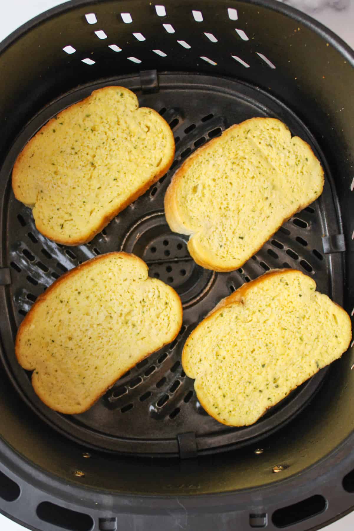frozen garlic toast in an air fryer basket