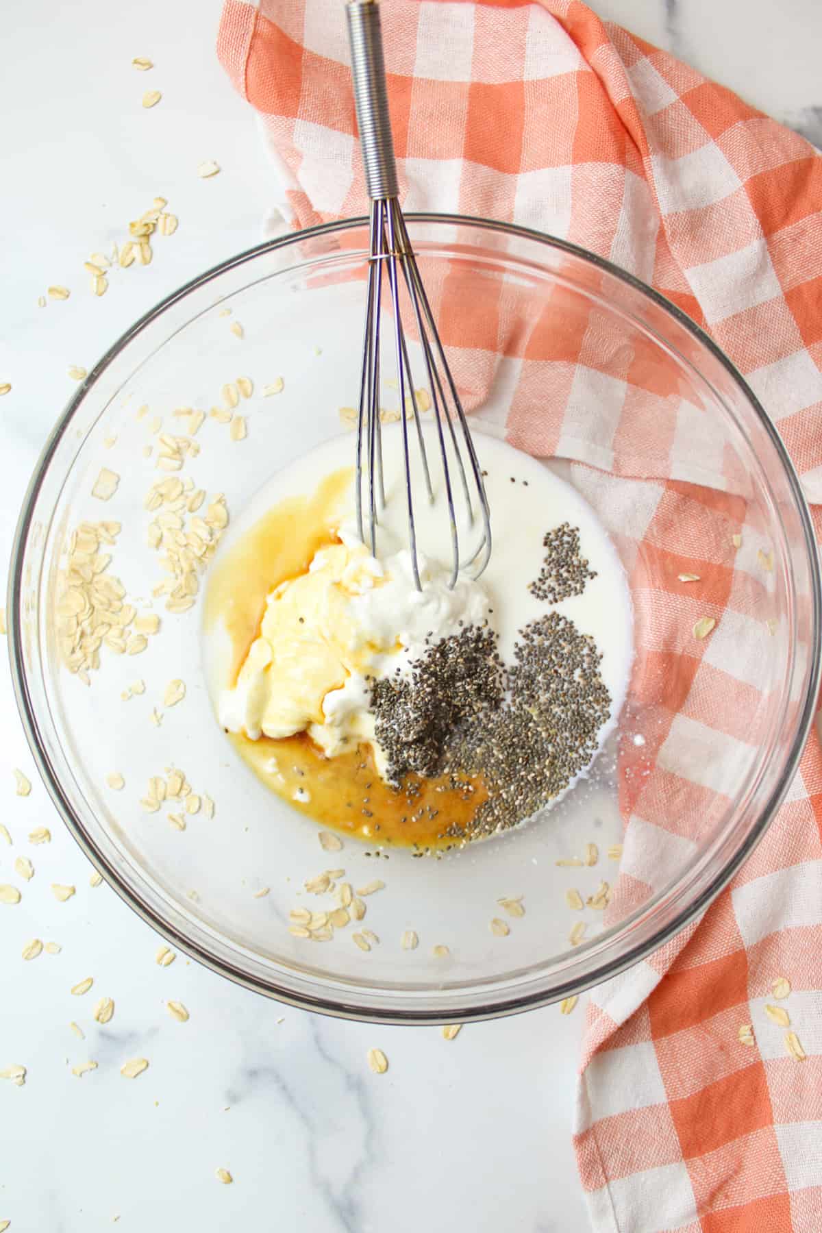 Mixing bowl with Greek yogurt, maple syrup, chia seeds, vanilla.