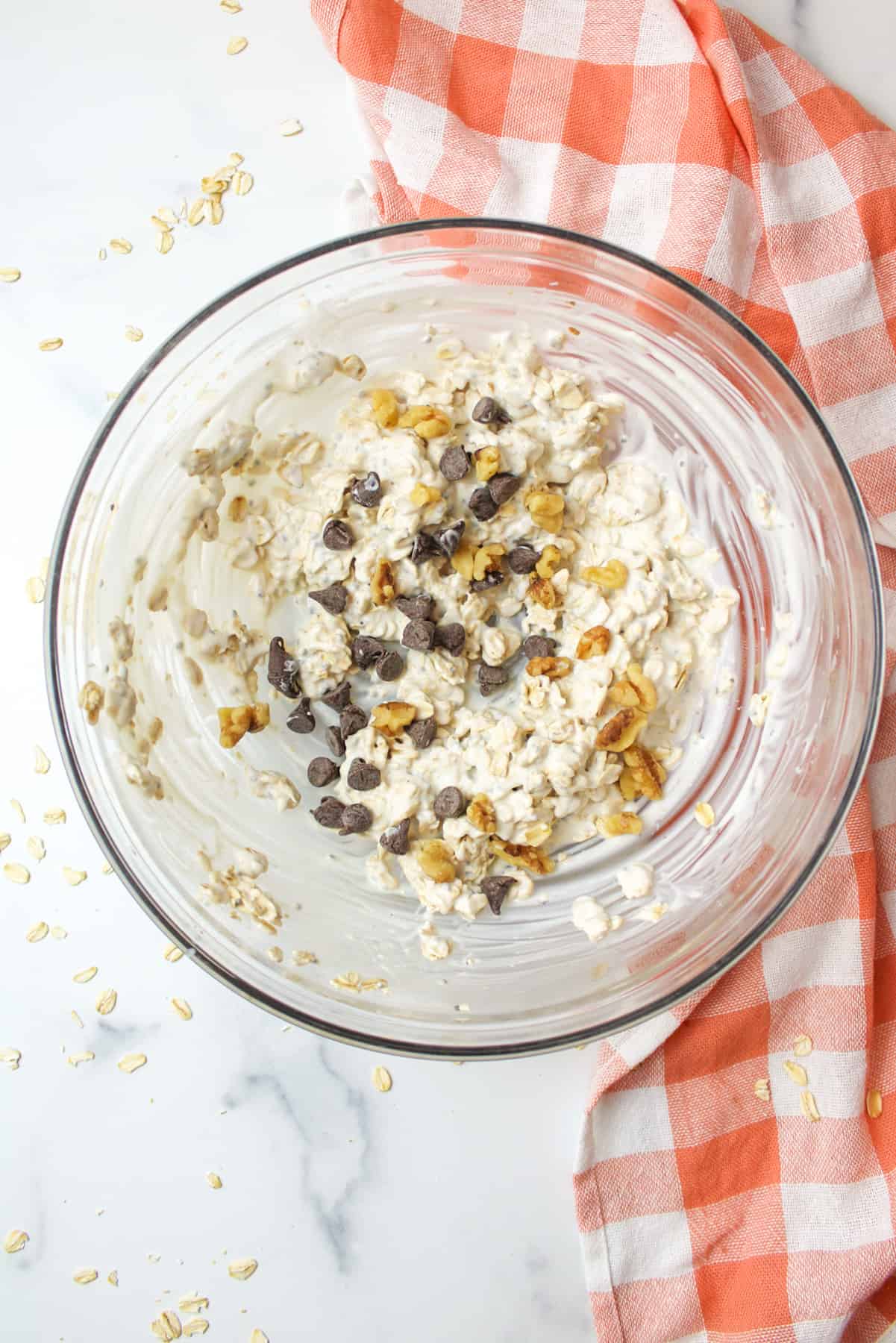 overnight oats mixture with walnuts and chocolate chips in a bowl
