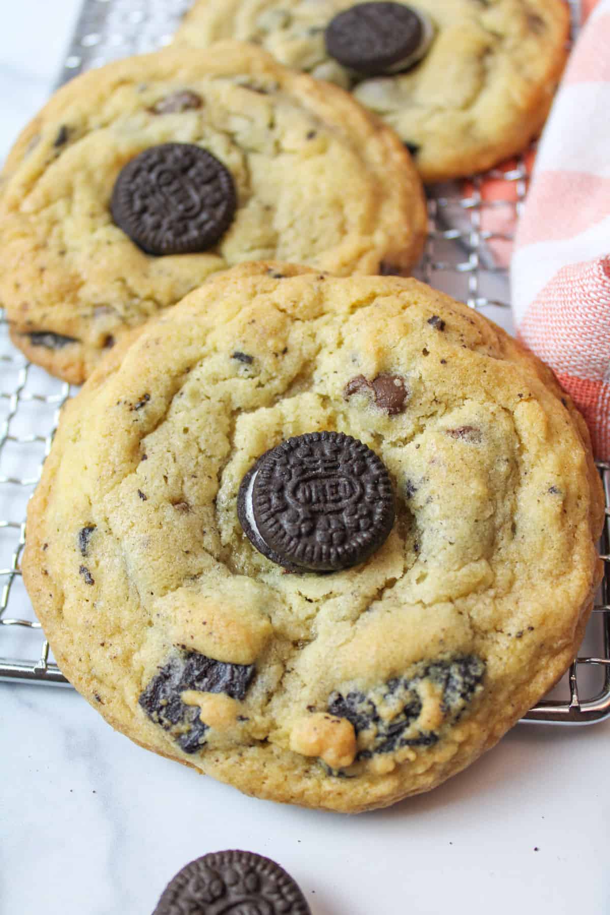 a close up of oreo chocolate chip cookies on a wire rack