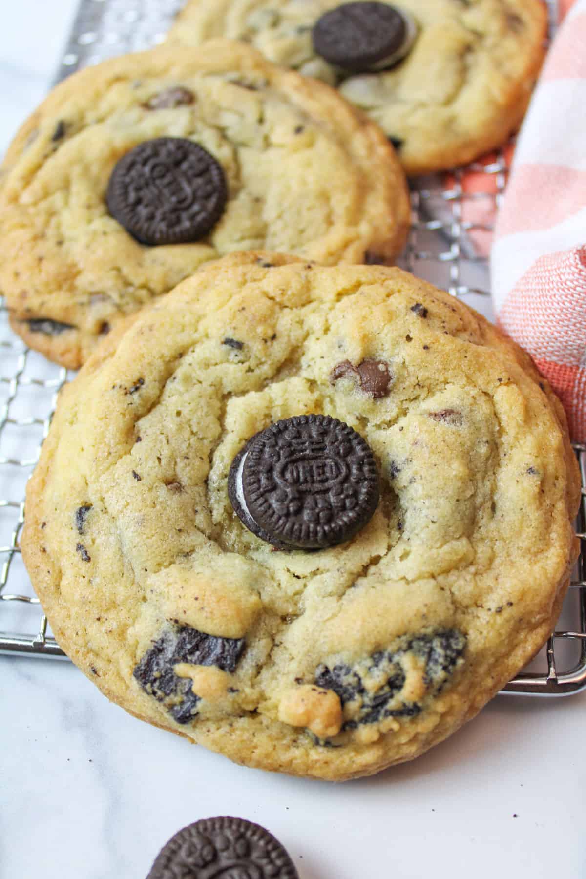 oreo chocolate chip cookies on a wire rack.