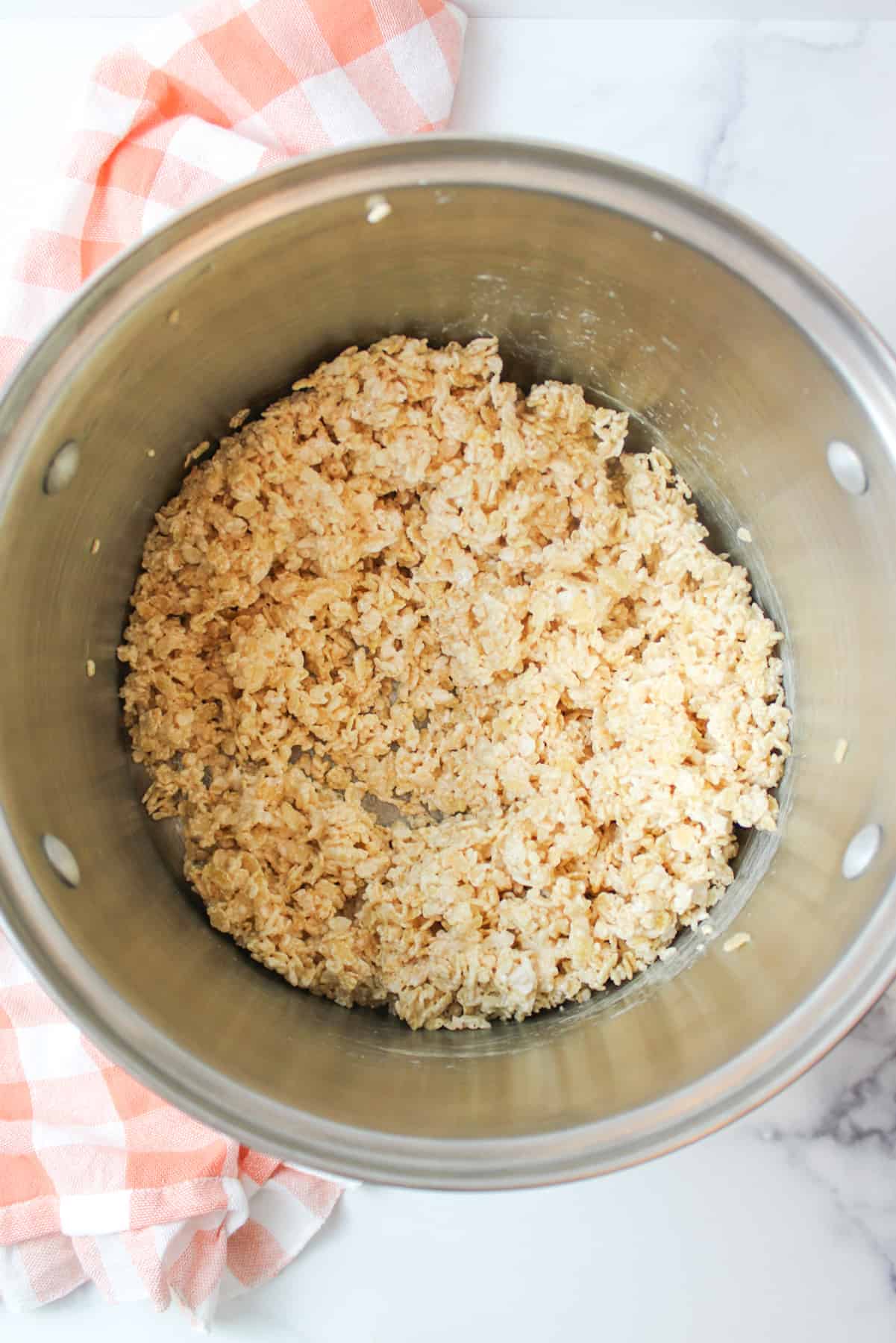 mixed Rice Krispies with Marshmallow Fluff in a pot.