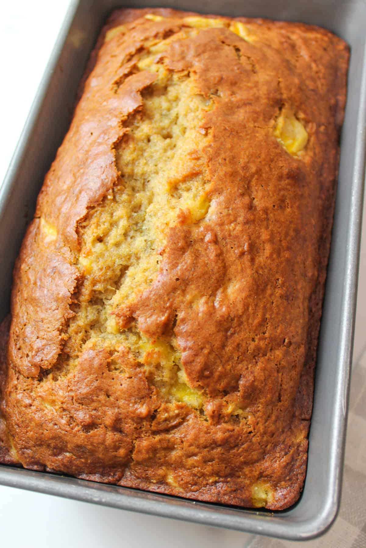up close angled view of a mango banana bread in loaf pan