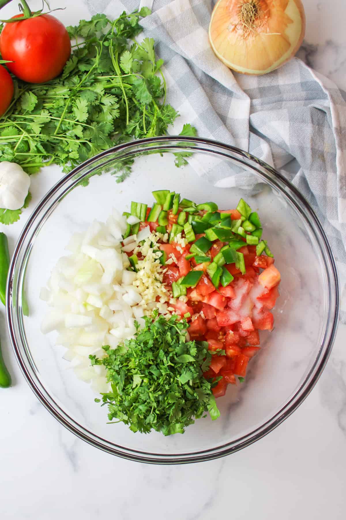 all of the salsa ingredients in a bowl, unmixed