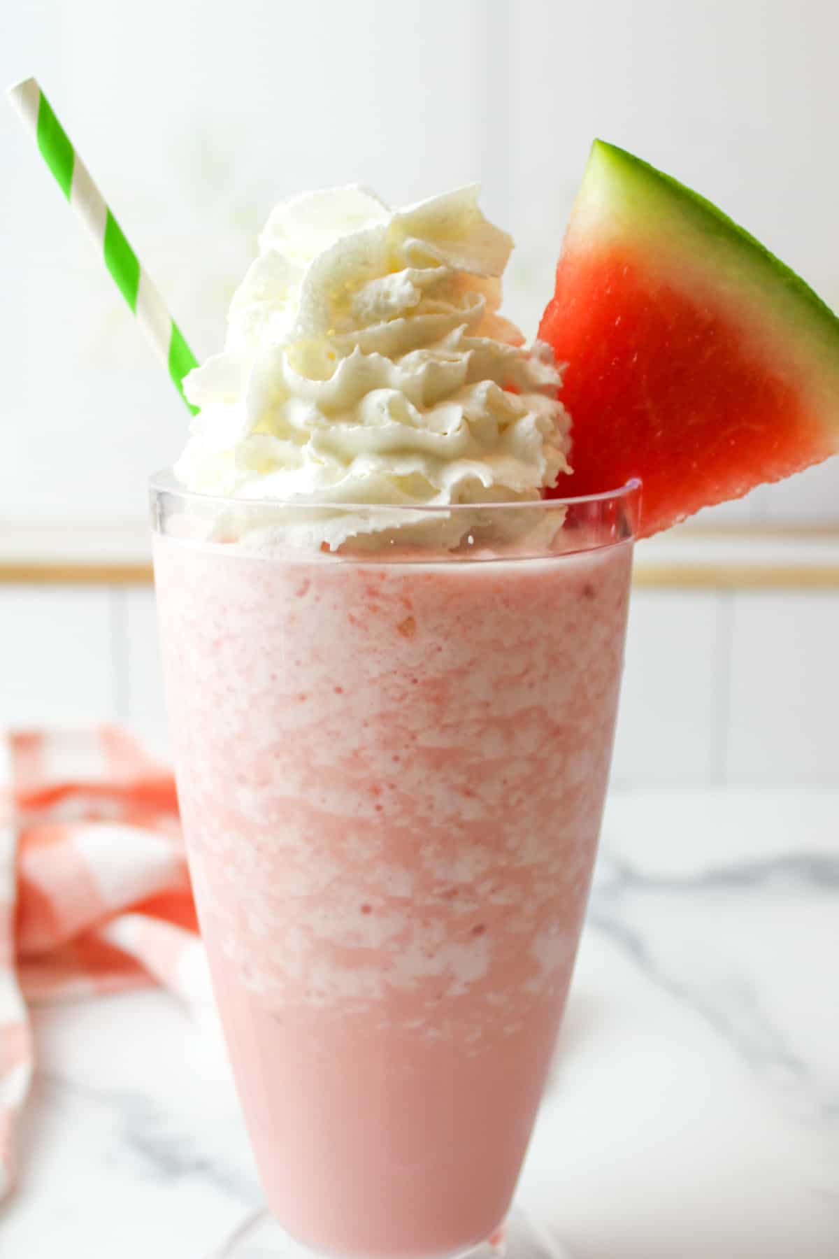 fresh watermelon and whipped cream garnished watermelon milkshake.