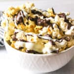 upclose view of chocolate drizzled popcorn in a bowl