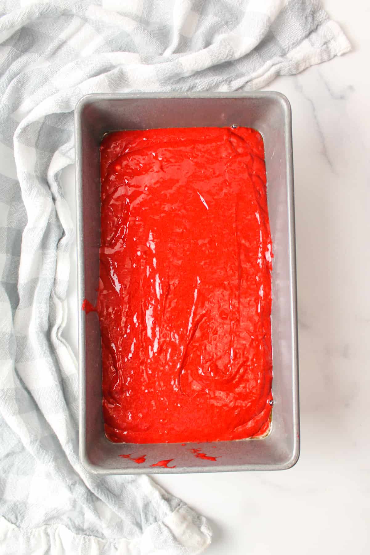 red velvet banana bread batter poured into a 9inch bread loaf pan