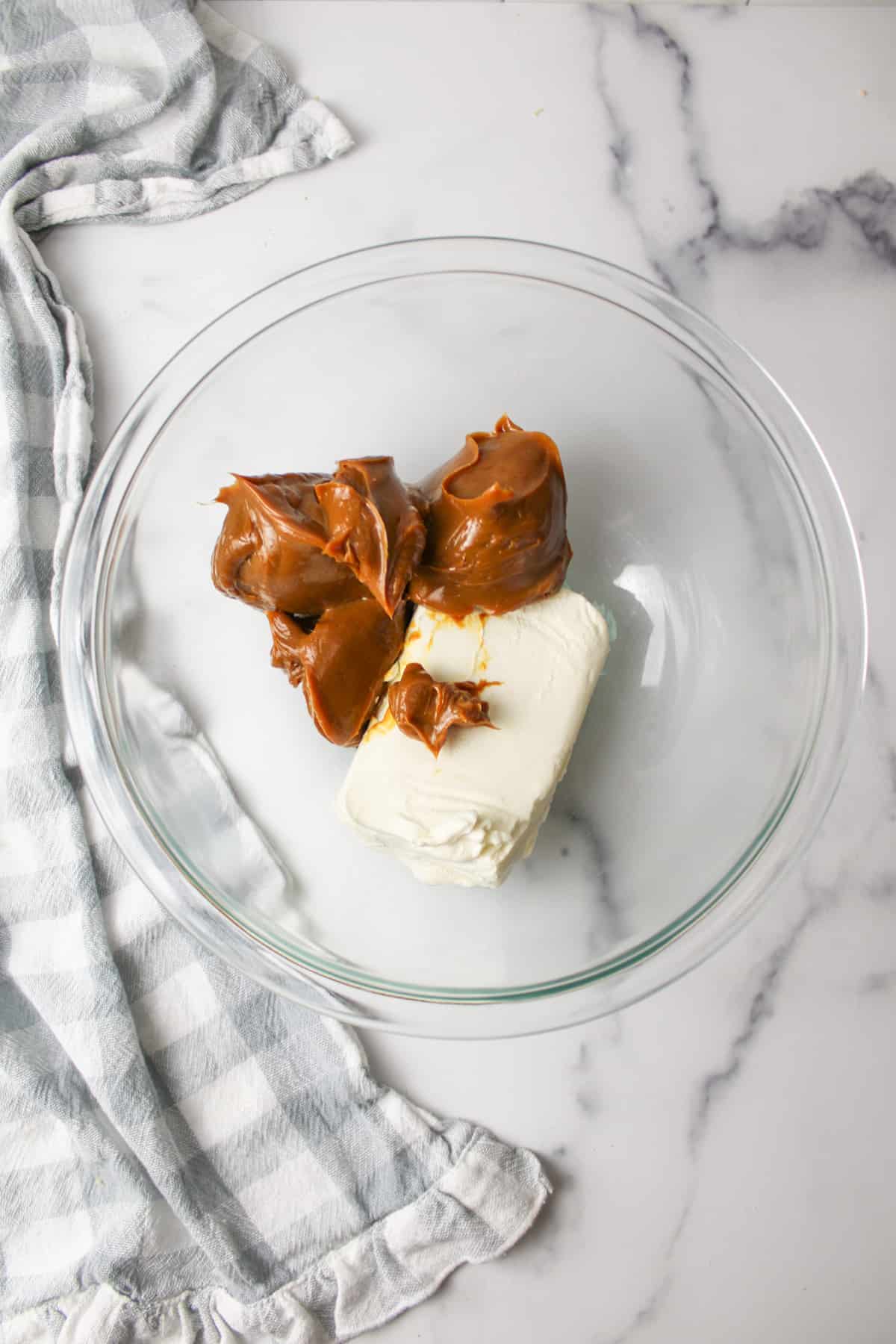 dulce de leche and cream cheese in a mixing bowl