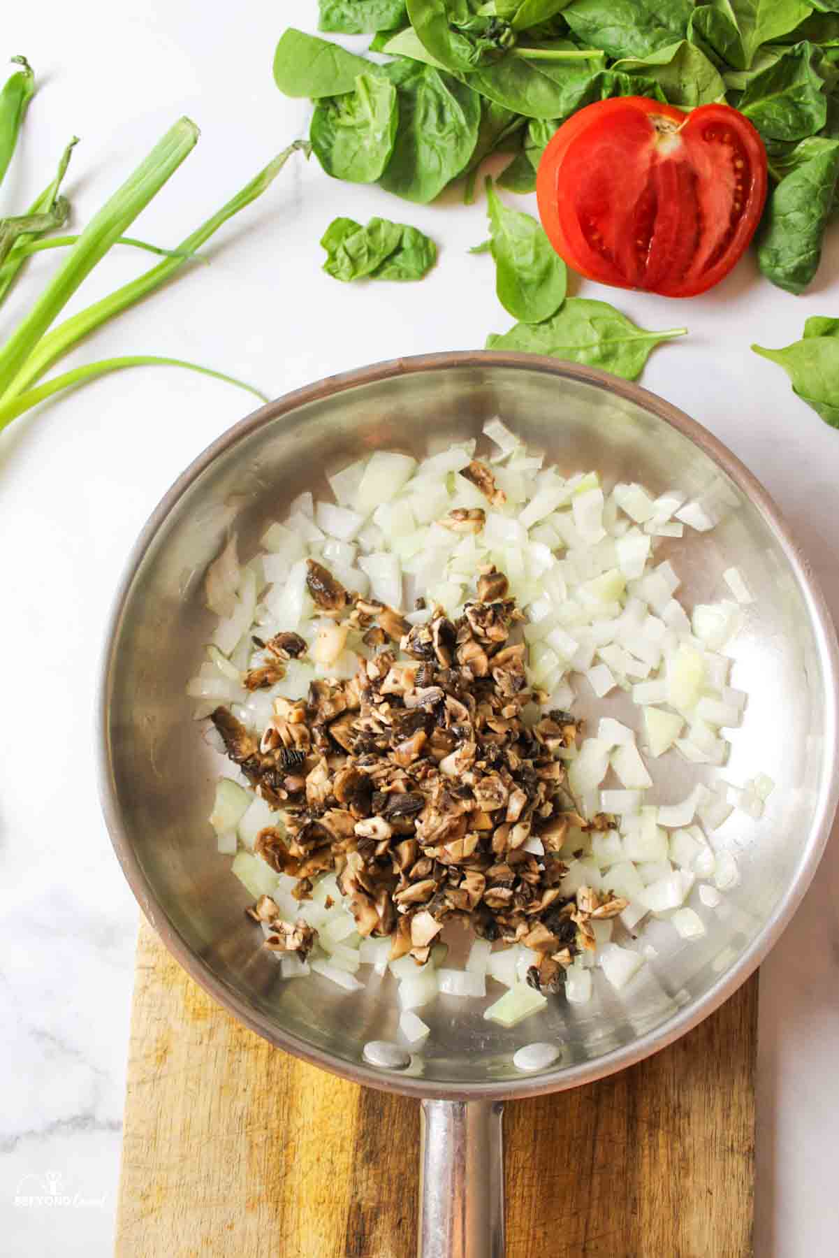 mushrooms and onions in a pan.