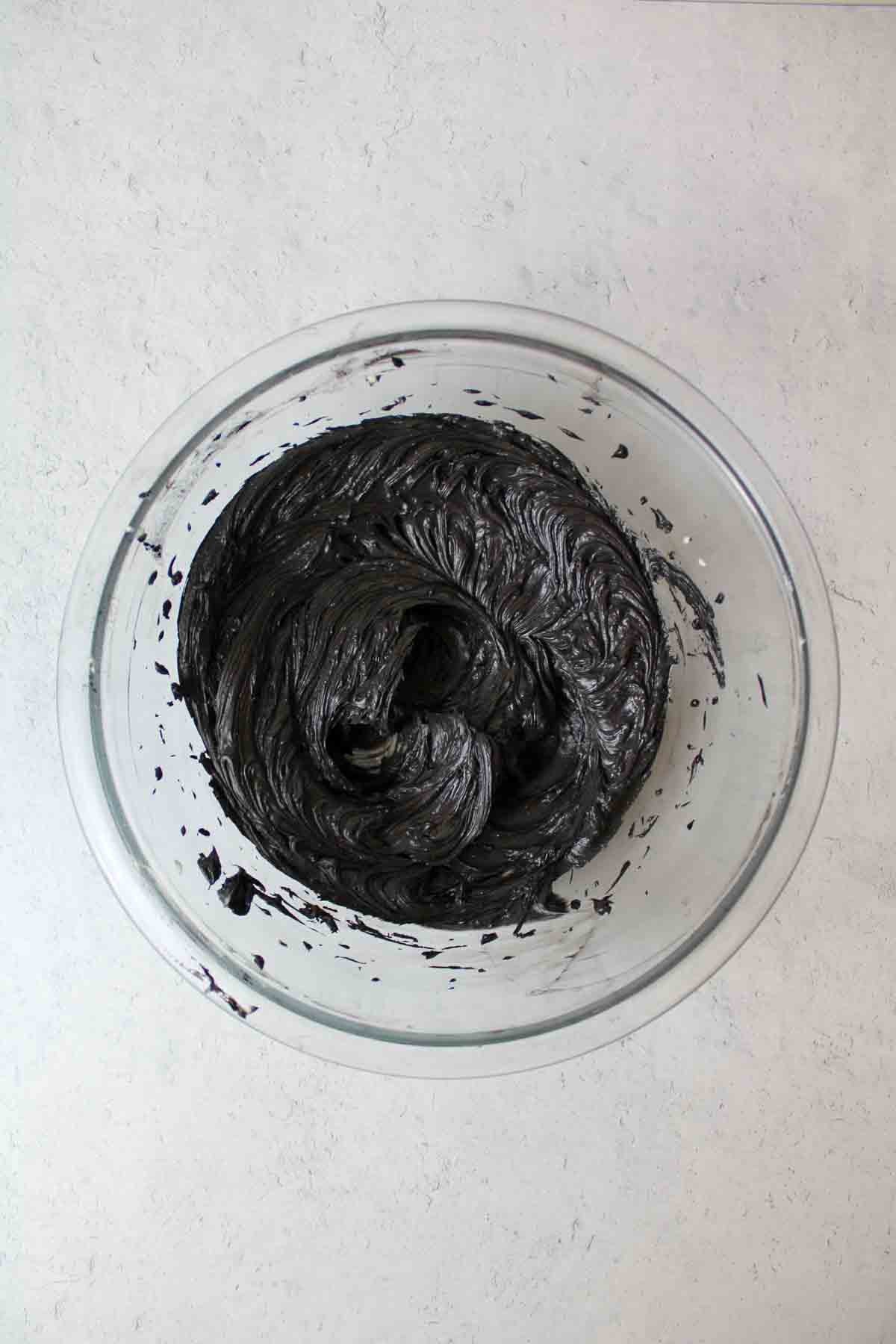black colored butter in a mixing bowl.