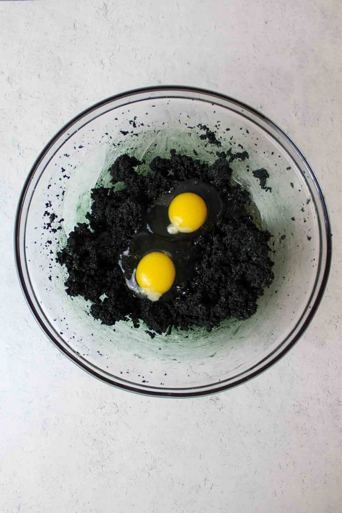 two eggs added to the black butter and sugar mixture.