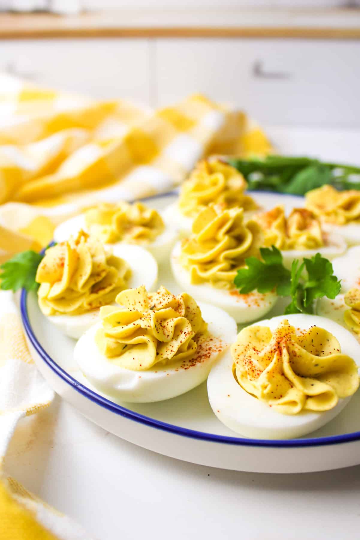 side view of southern deviled eggs on a plate with fresh parsley