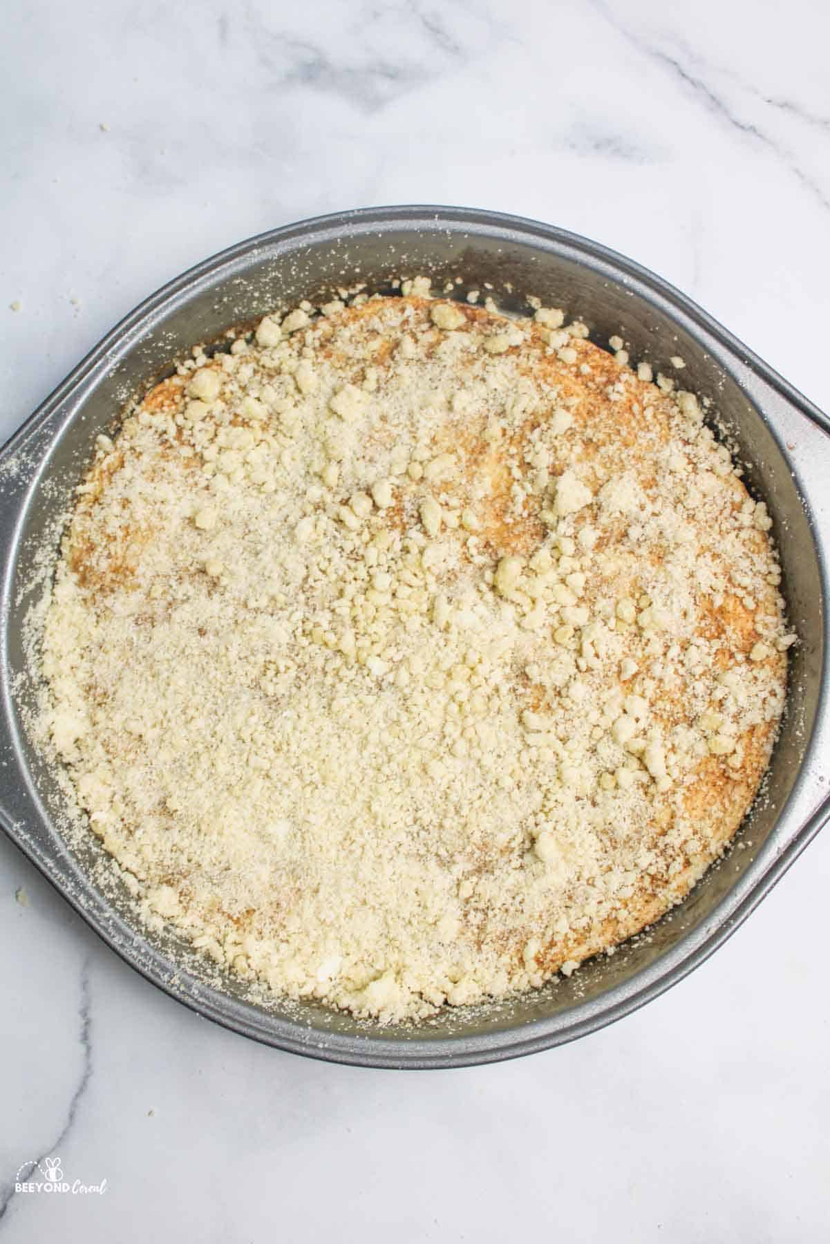 aerial view of streusel topped cinnamon pizza in cake pan