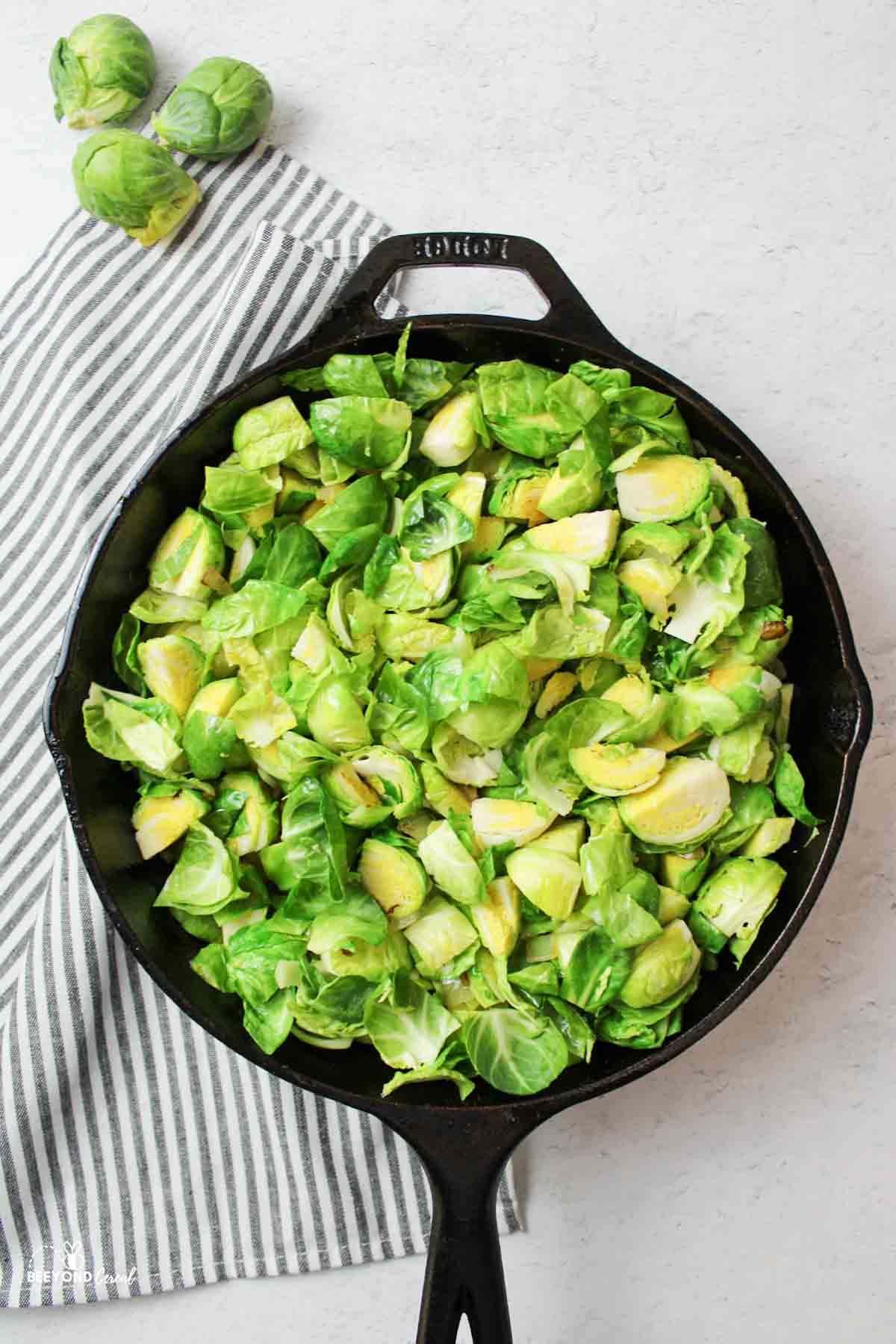 quartered brussel sprouts in a cast iron skillet