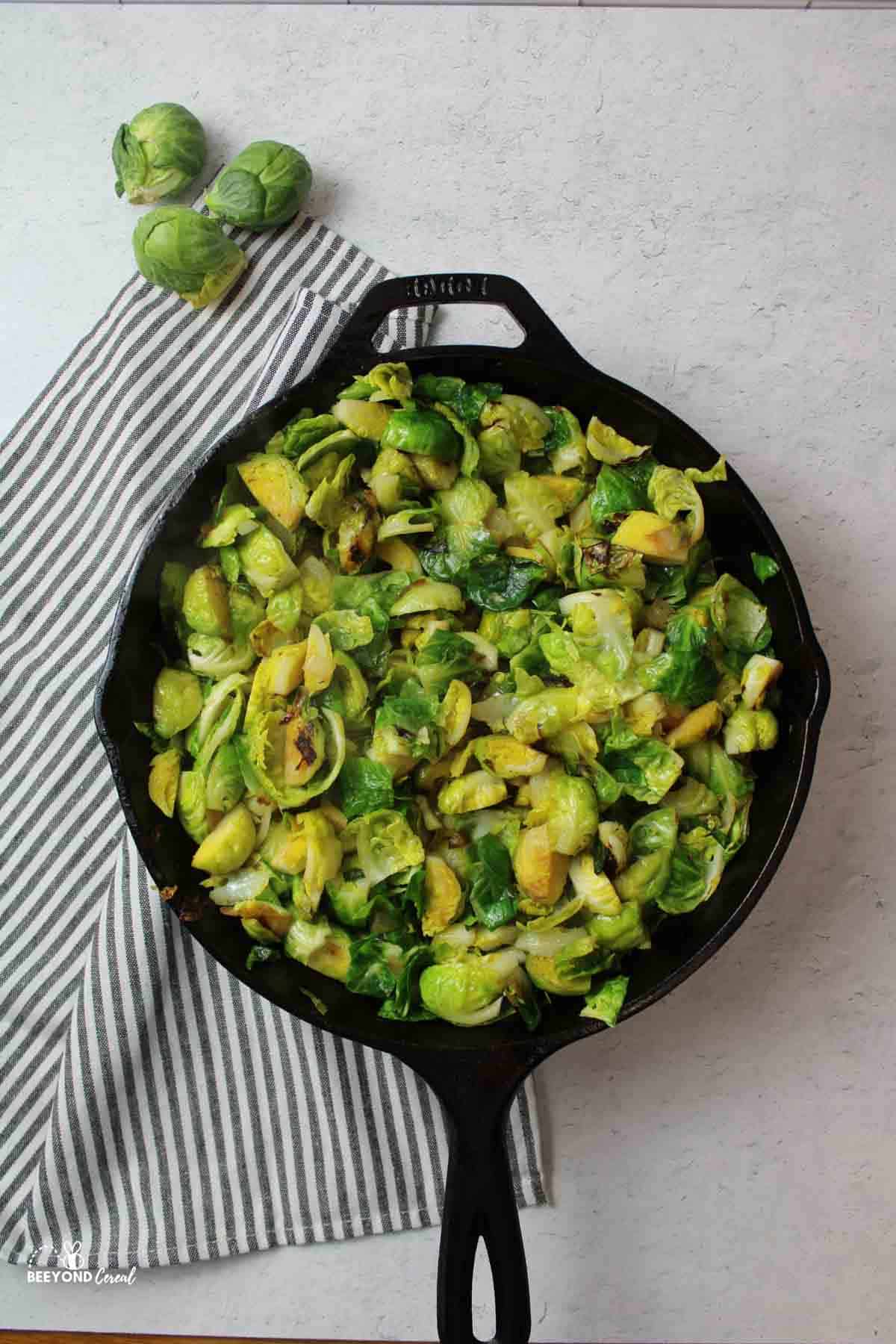 cooked brussel sprouts in a cast iron skillet.