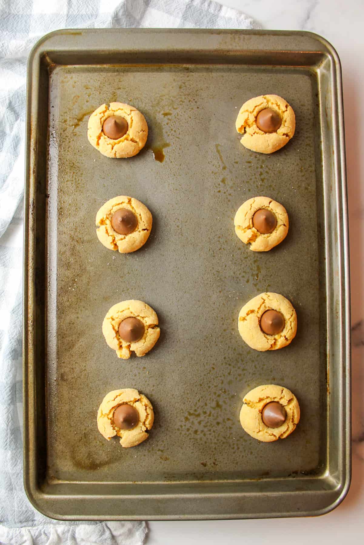 peanut butter blossom cookies on a baking sheet.