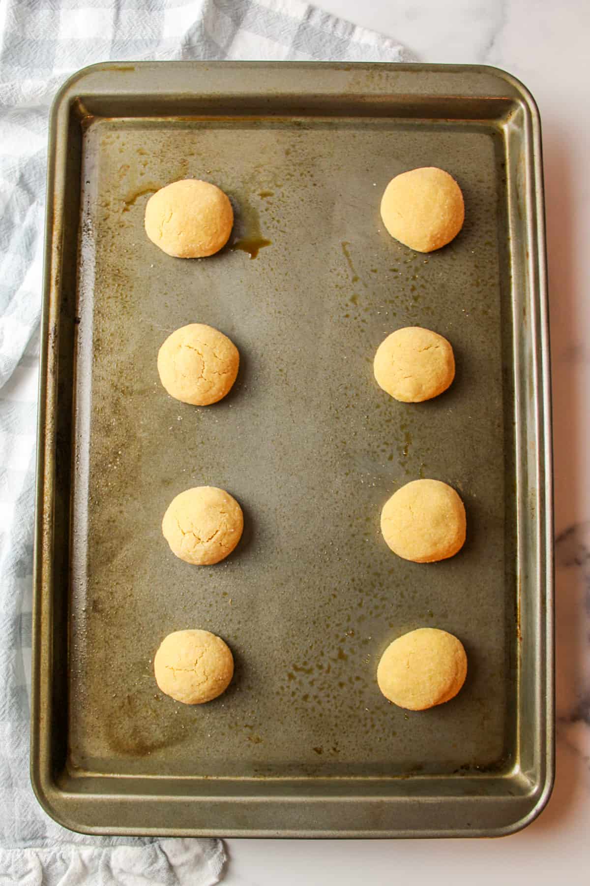 baked peanut butter dough balls on a baking sheet.
