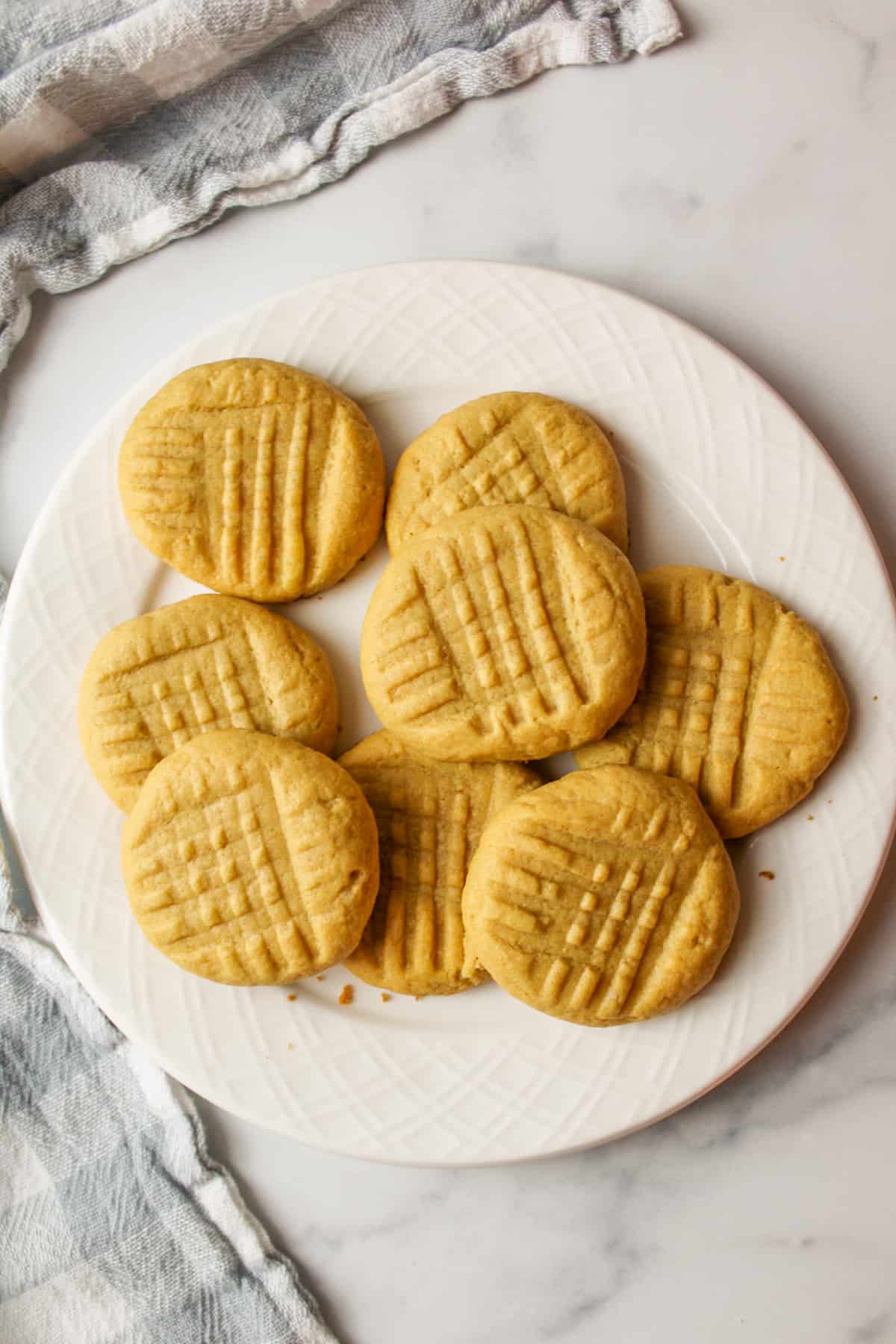 a plate full of peanut butter cake mix cookies.