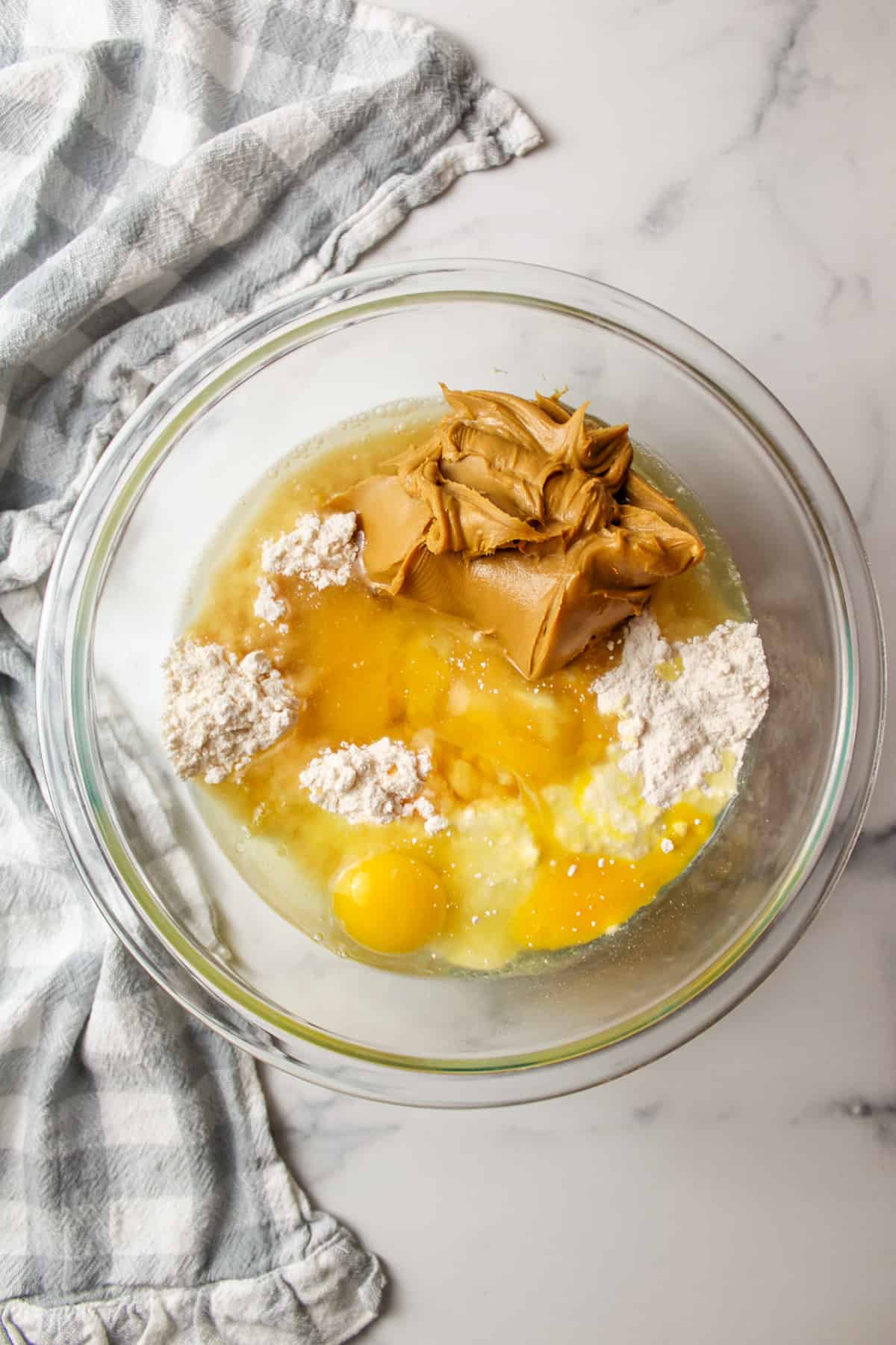 ingredients needed to make peanut butter cookies with cake mix in a mixing bowl.