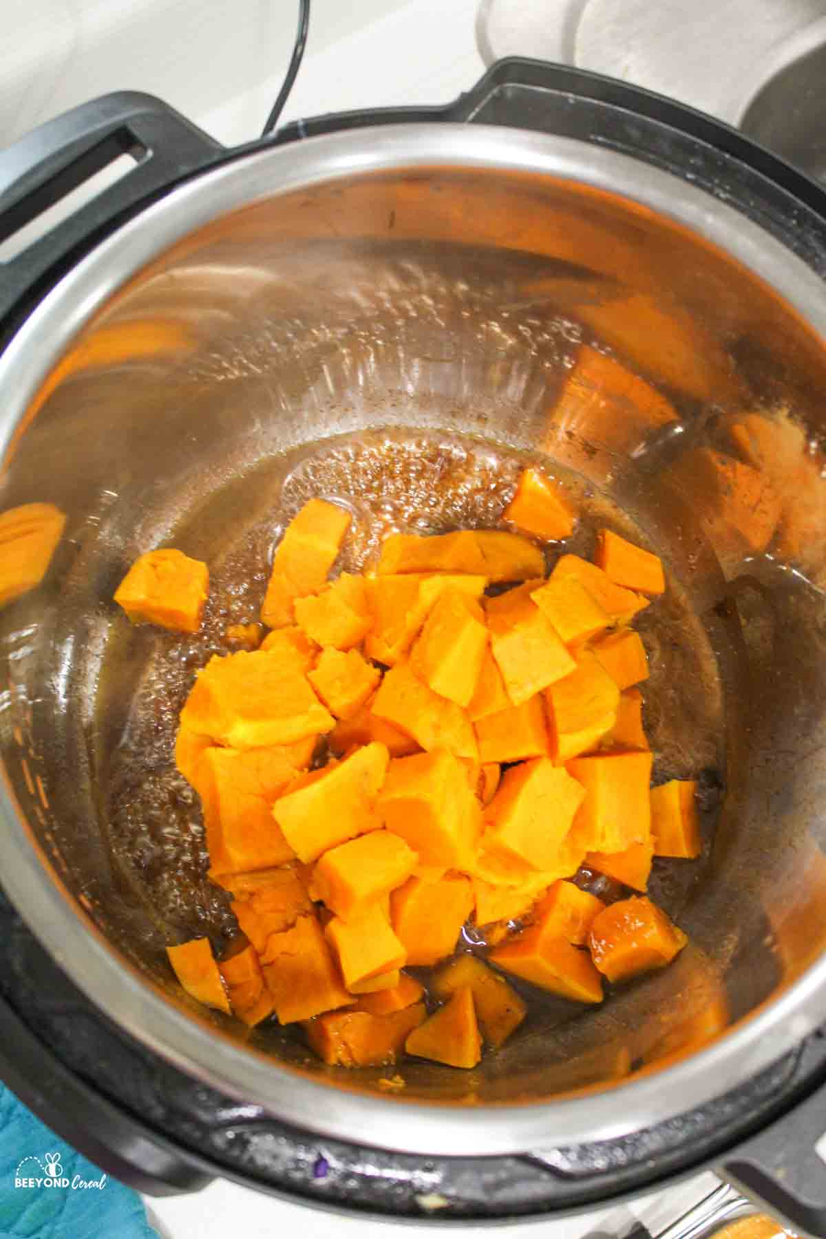 cooked sweet potatoes in an instant pot with spiced butter mixture