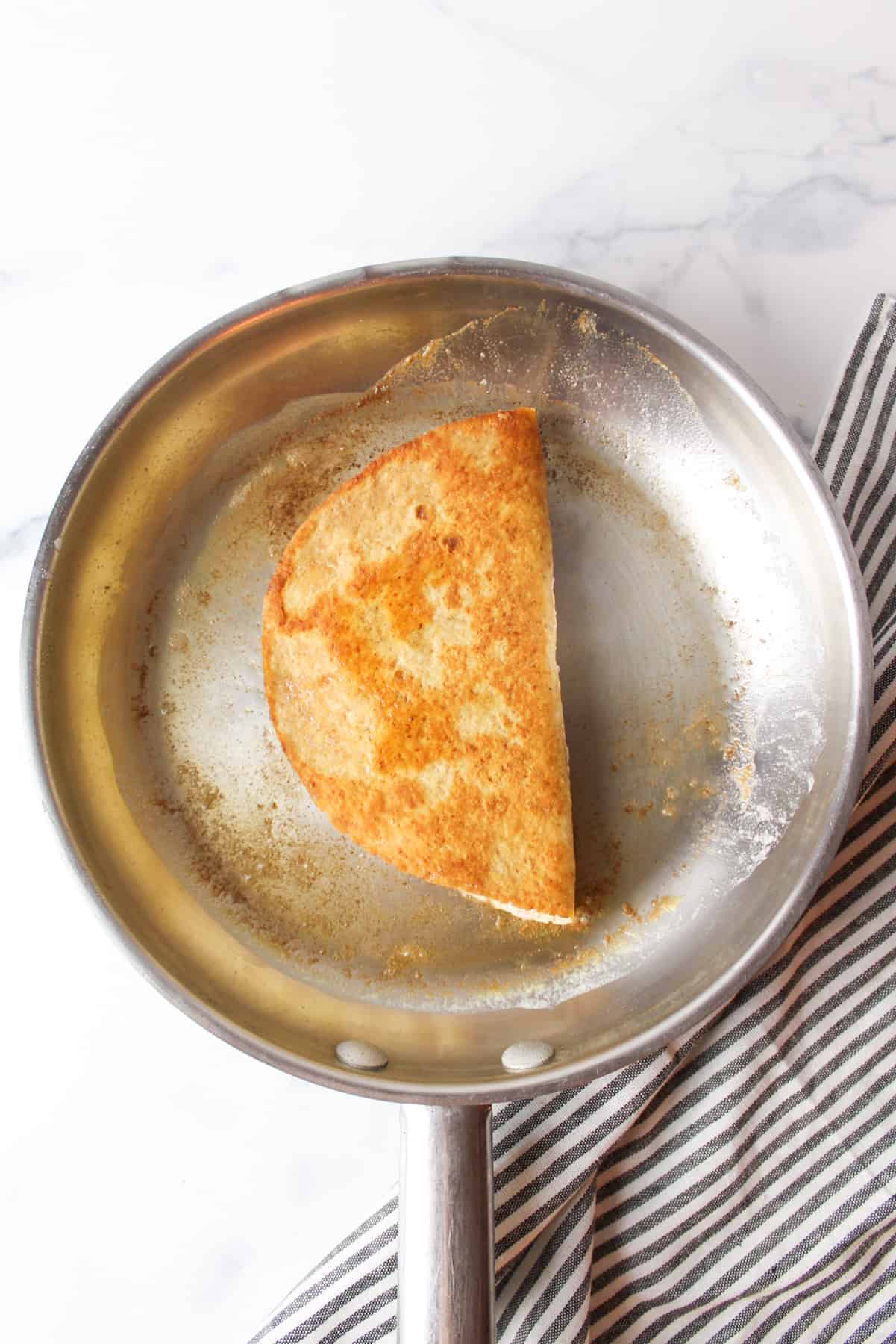 cooked quesadilla in a skillet