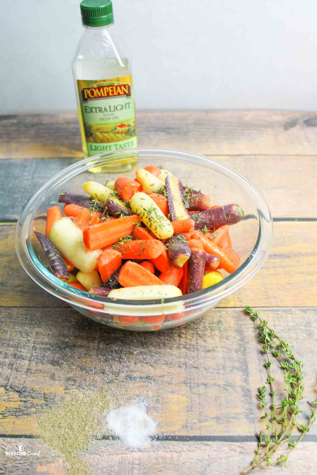 seasonings added to baby carrots in a bowl