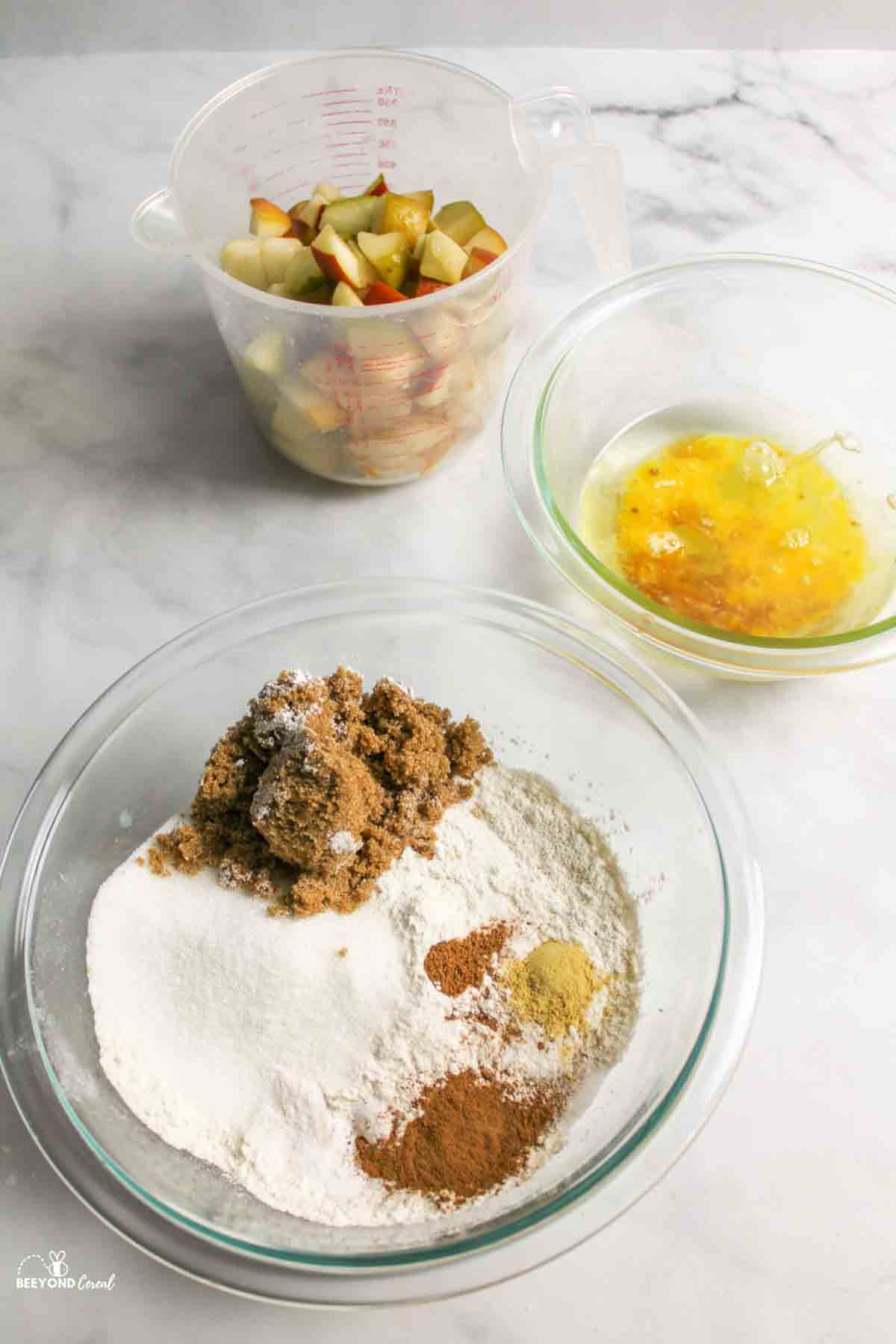 dry ingredients in one bowl, wet ingredients in another bowl and chopped pears in a third container