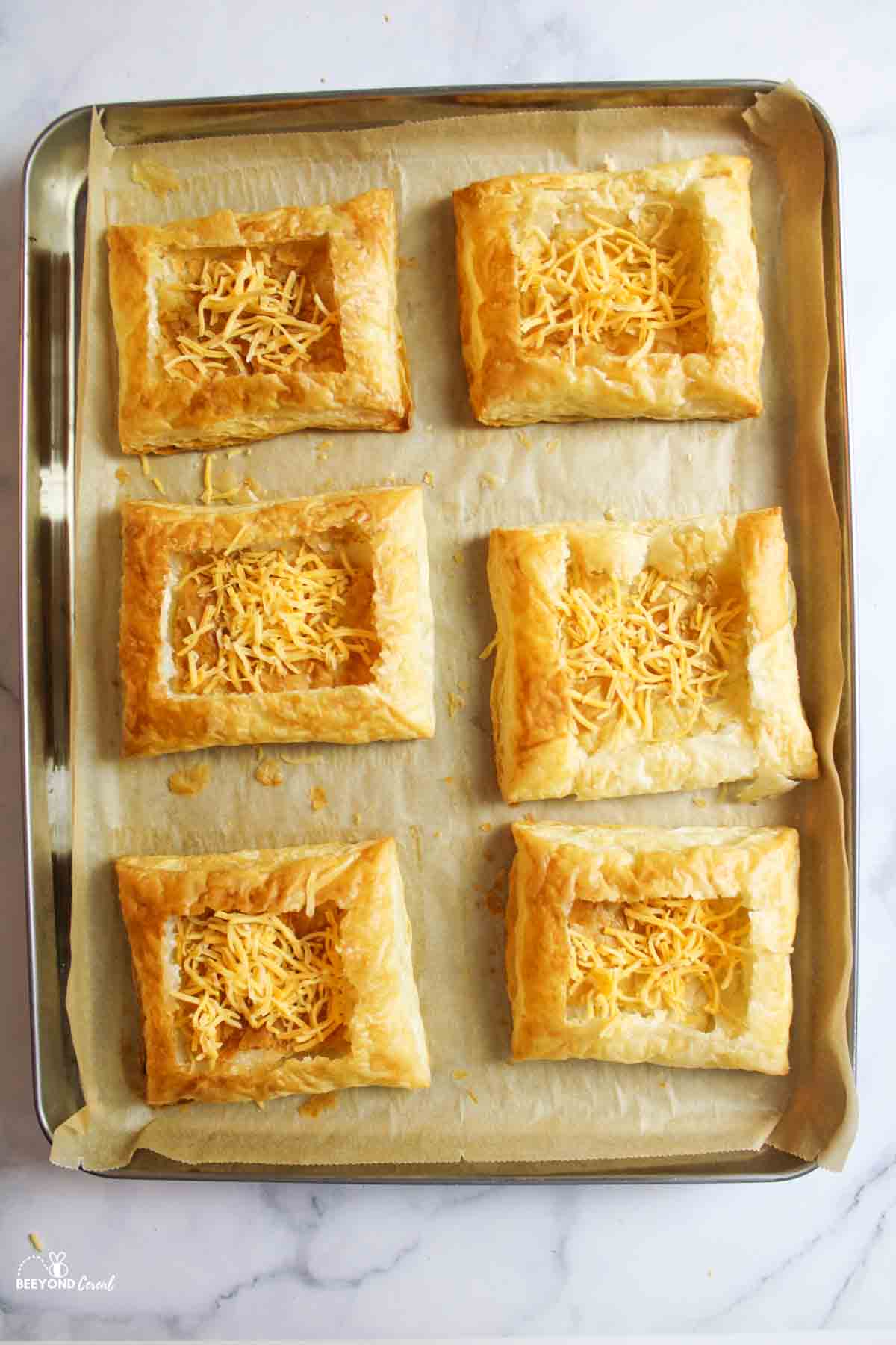 cheese sprinkled into the center of puff pastry squares