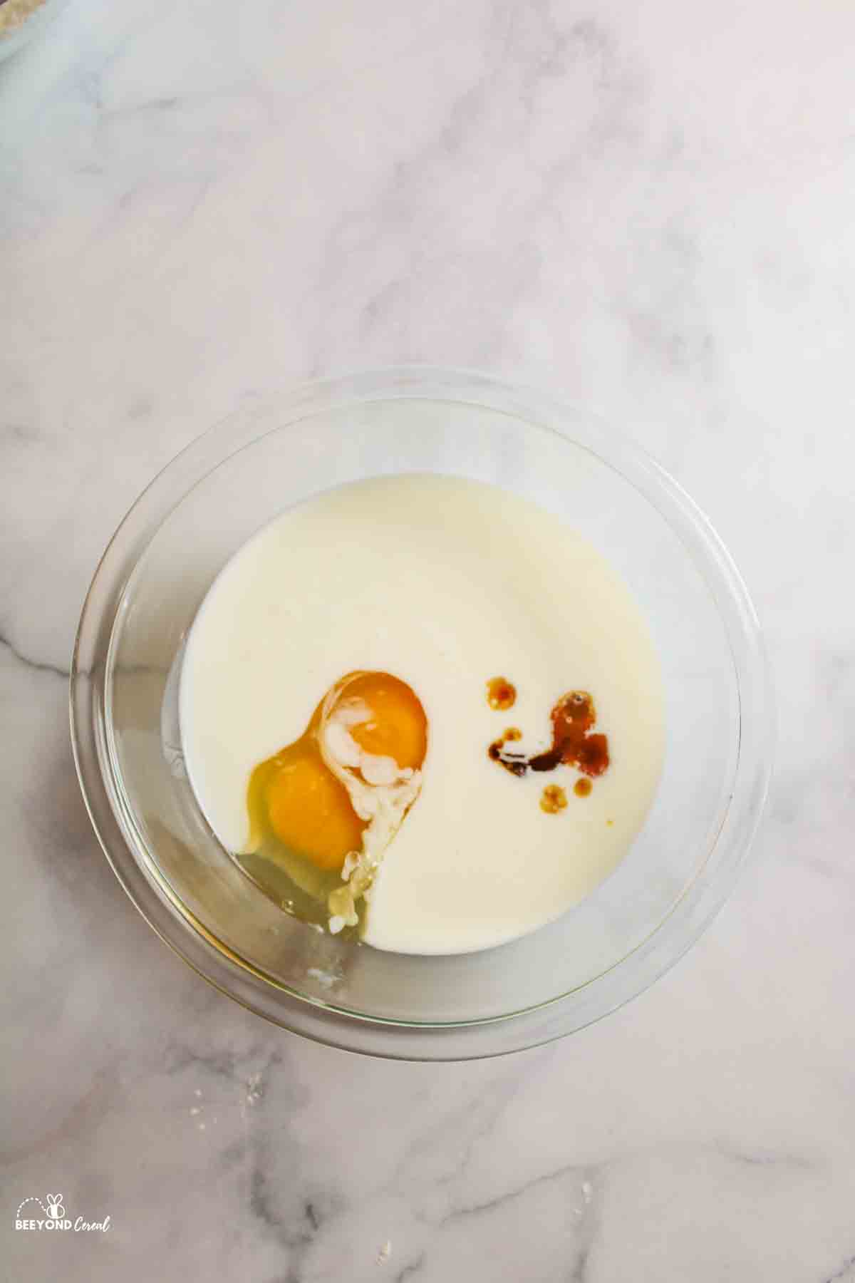 eggs, milk, and vanilla in a mixing bowl.