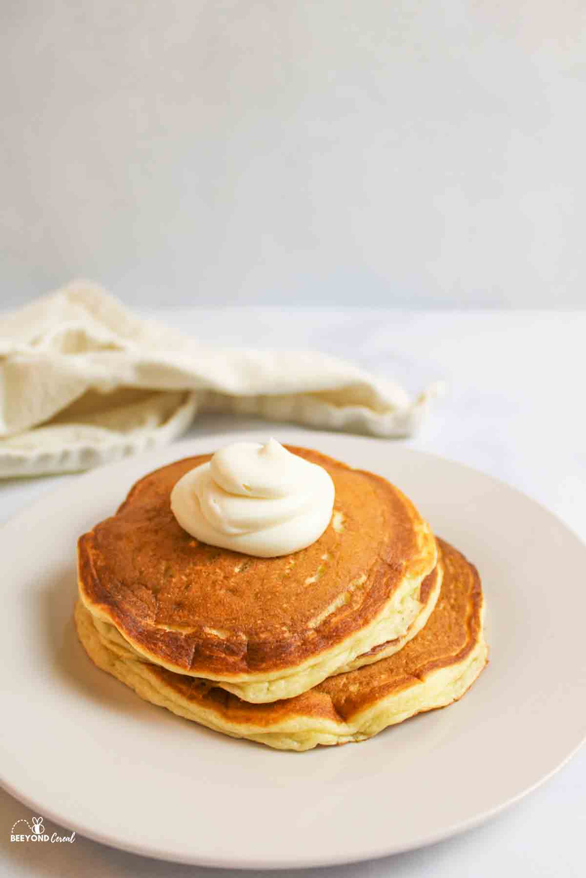 cooked pancakes on a plate topped with cheesecake filling.