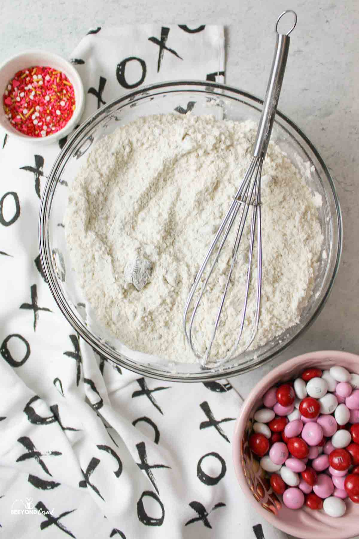 whisked dry ingredients in a mixing bowl with a whisk