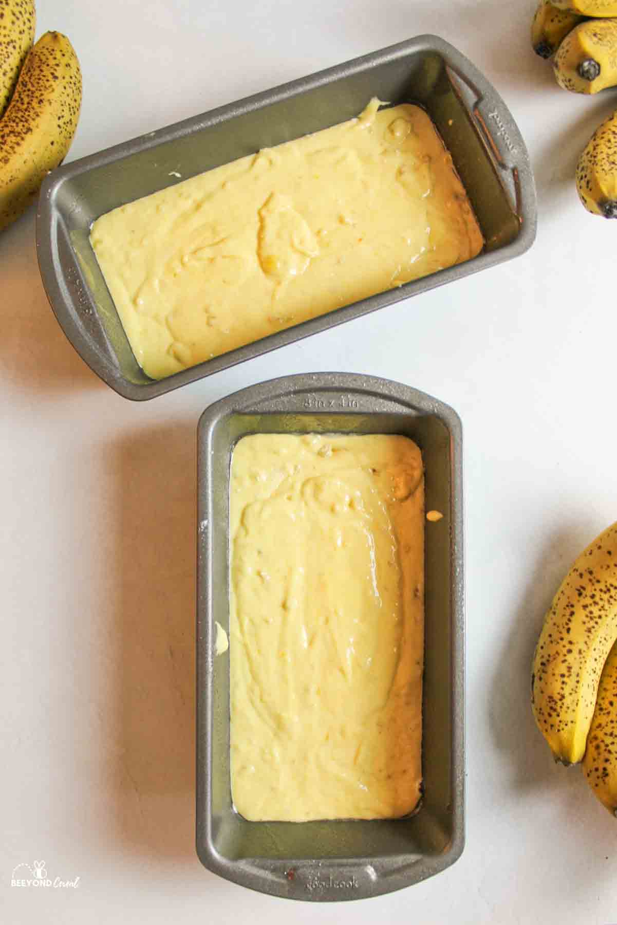 two loaf pans filled with cake mix banana bread batter.