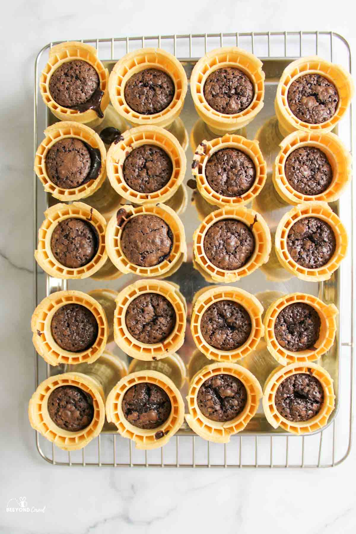 baked brownies in ice cream cones on wire rack.