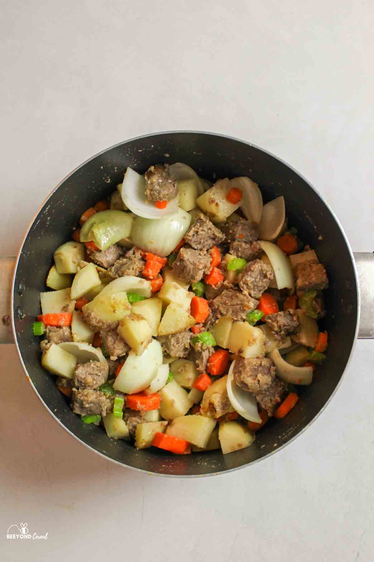 cooked veggies and beef in a large pot.