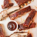 close aerial view of sliced bbq pork ribs on a wooden cutting board