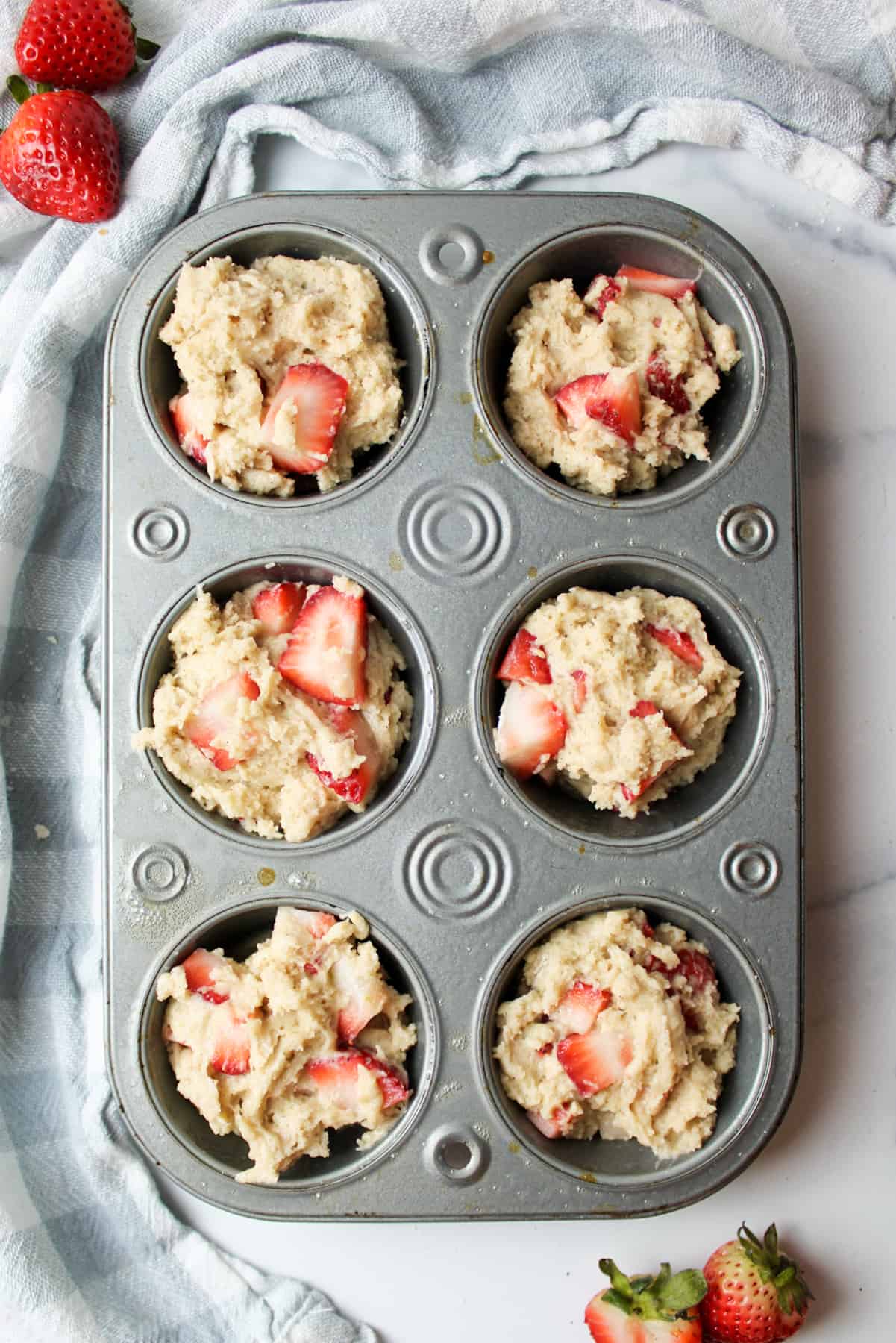 unbaked strawberry muffins in a muffin pan
