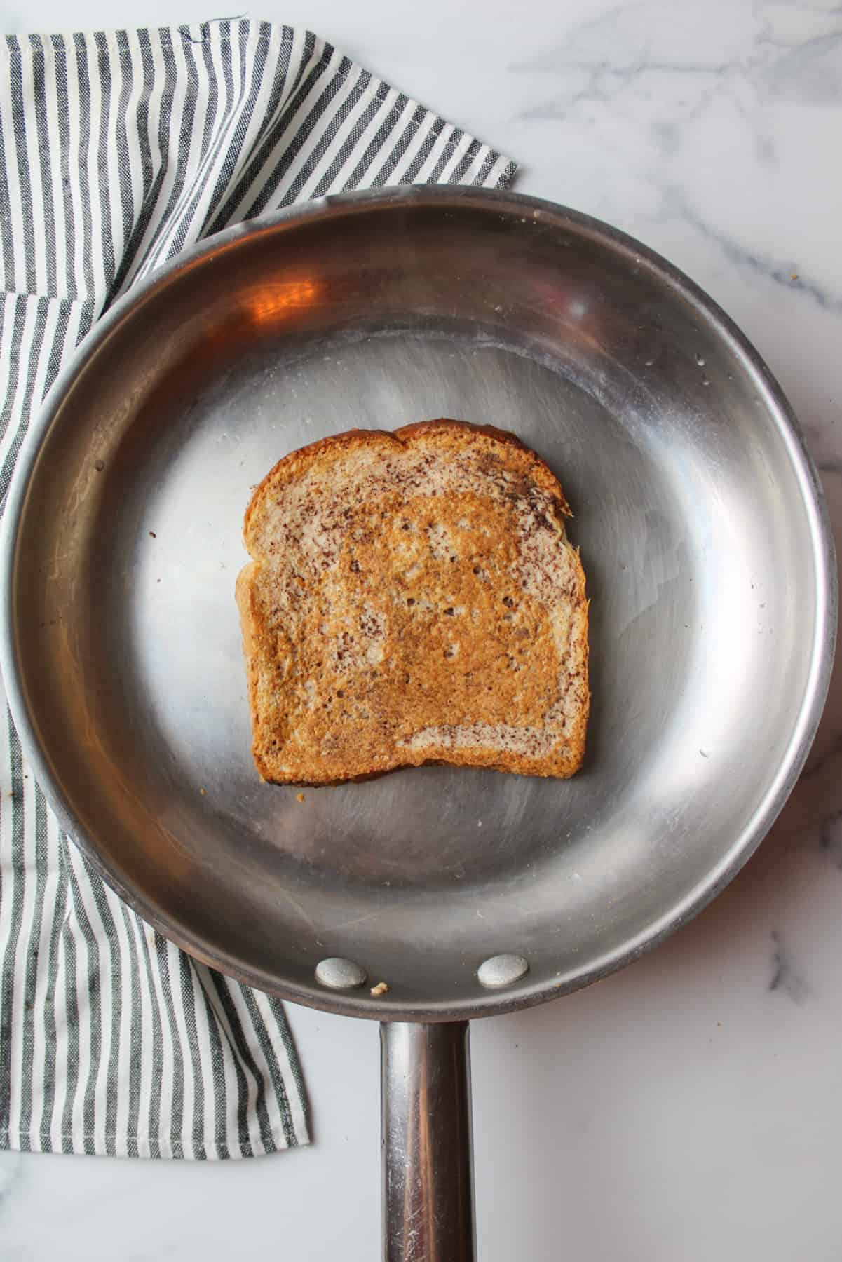 cooked french toast slice in a skillet.