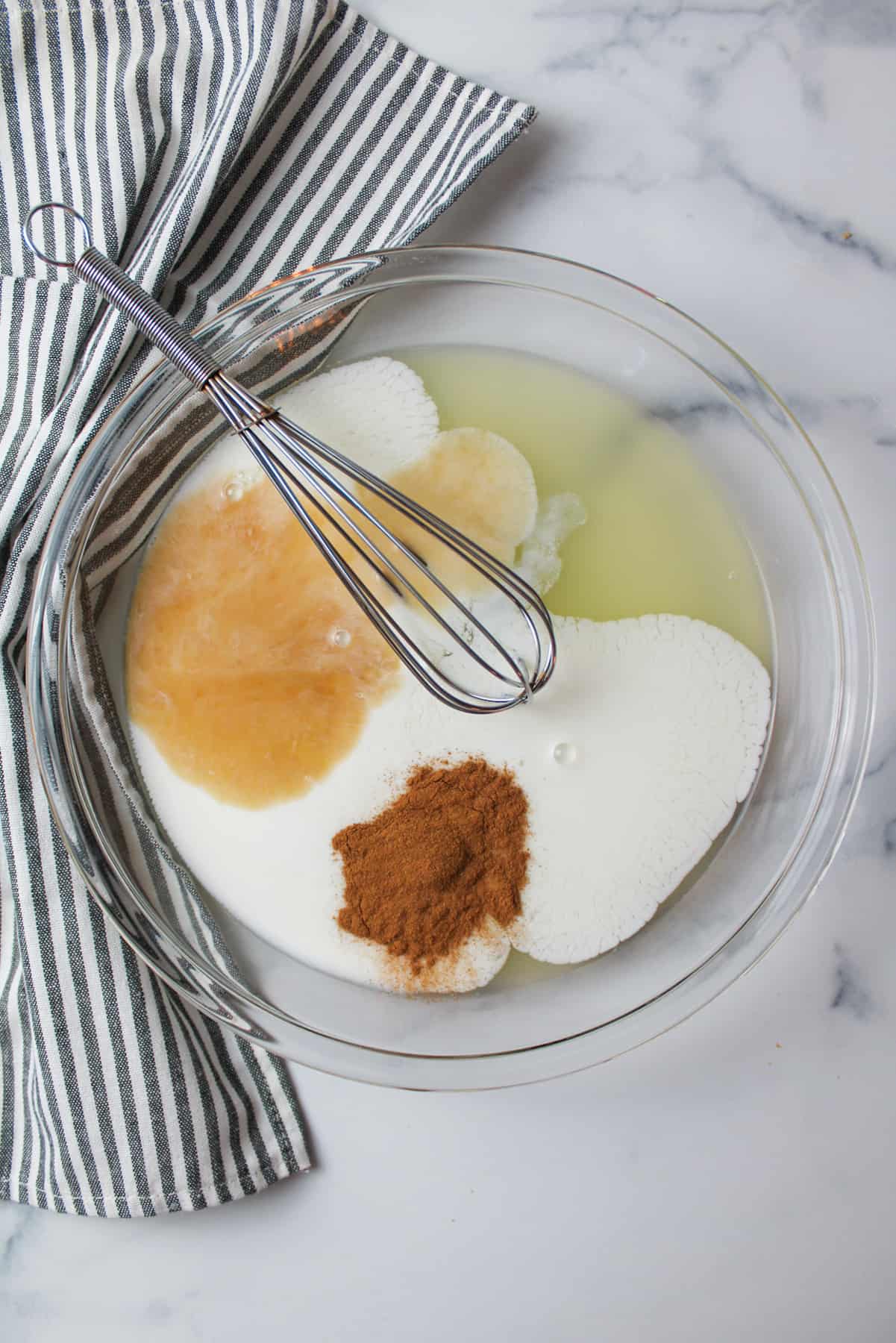 egg, milk, vanilla and cinnamon in a pie plate with a whisk.