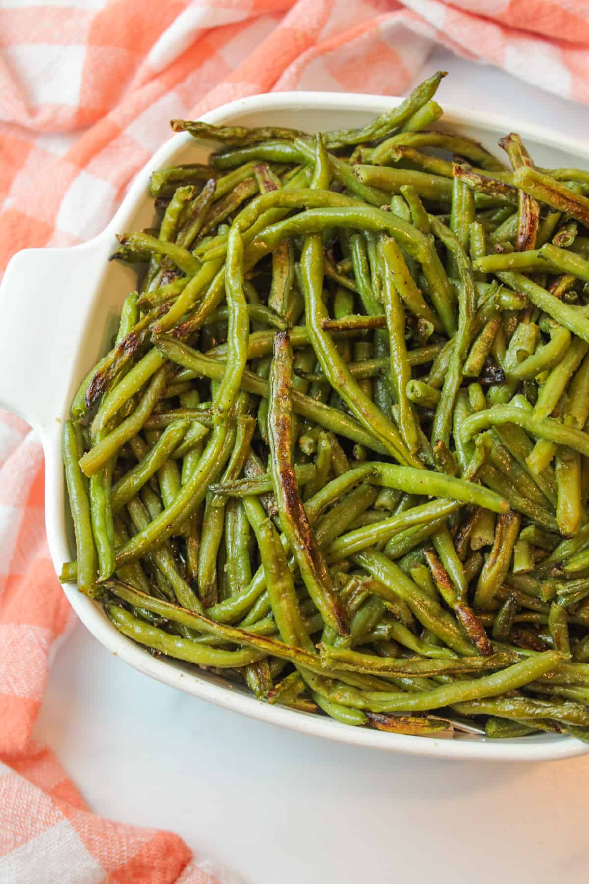 aerial view of an anlged baking dish filled with roasted green beans