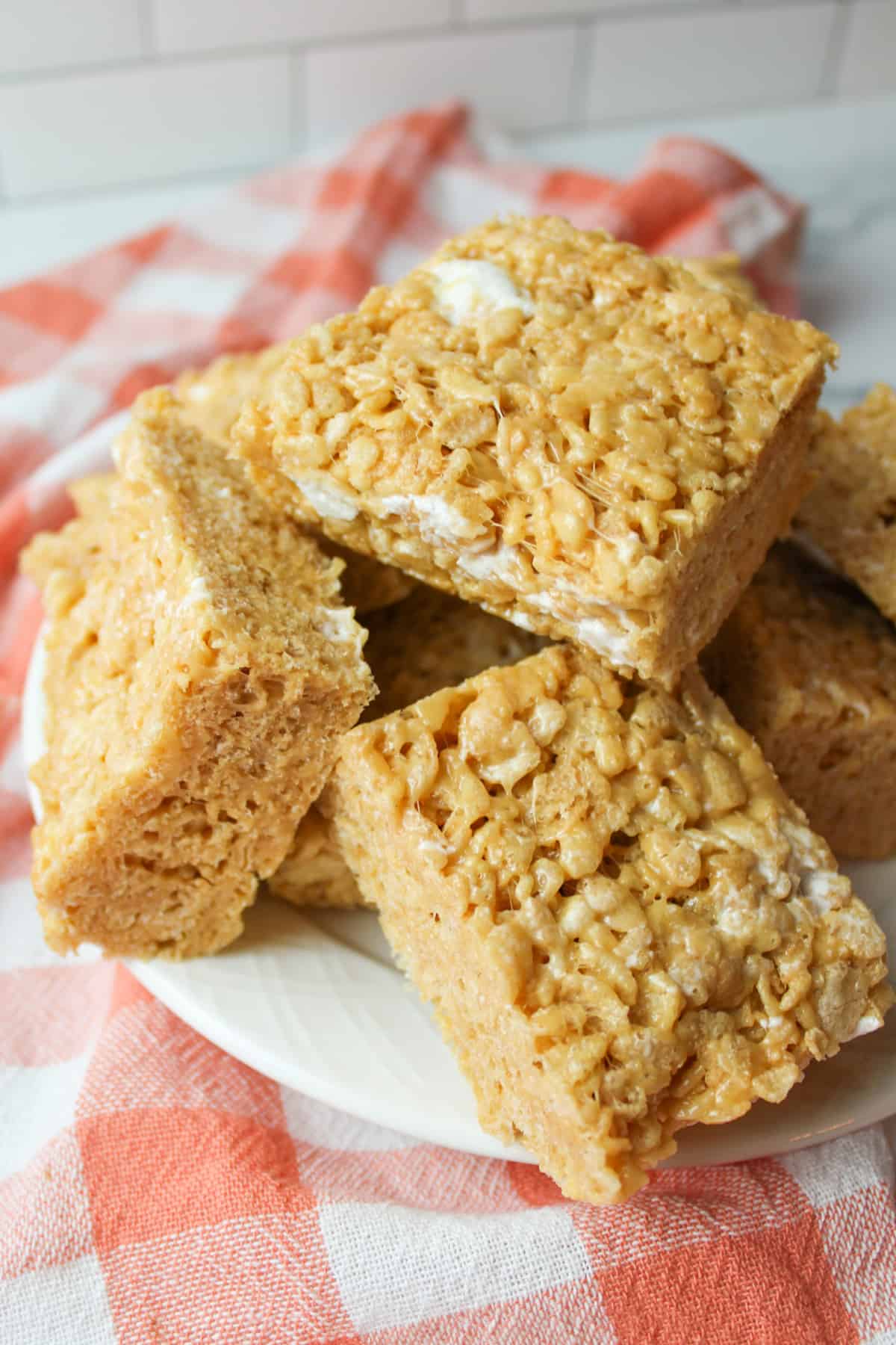 plate stacked with peanut butter rice krispie treat squares.